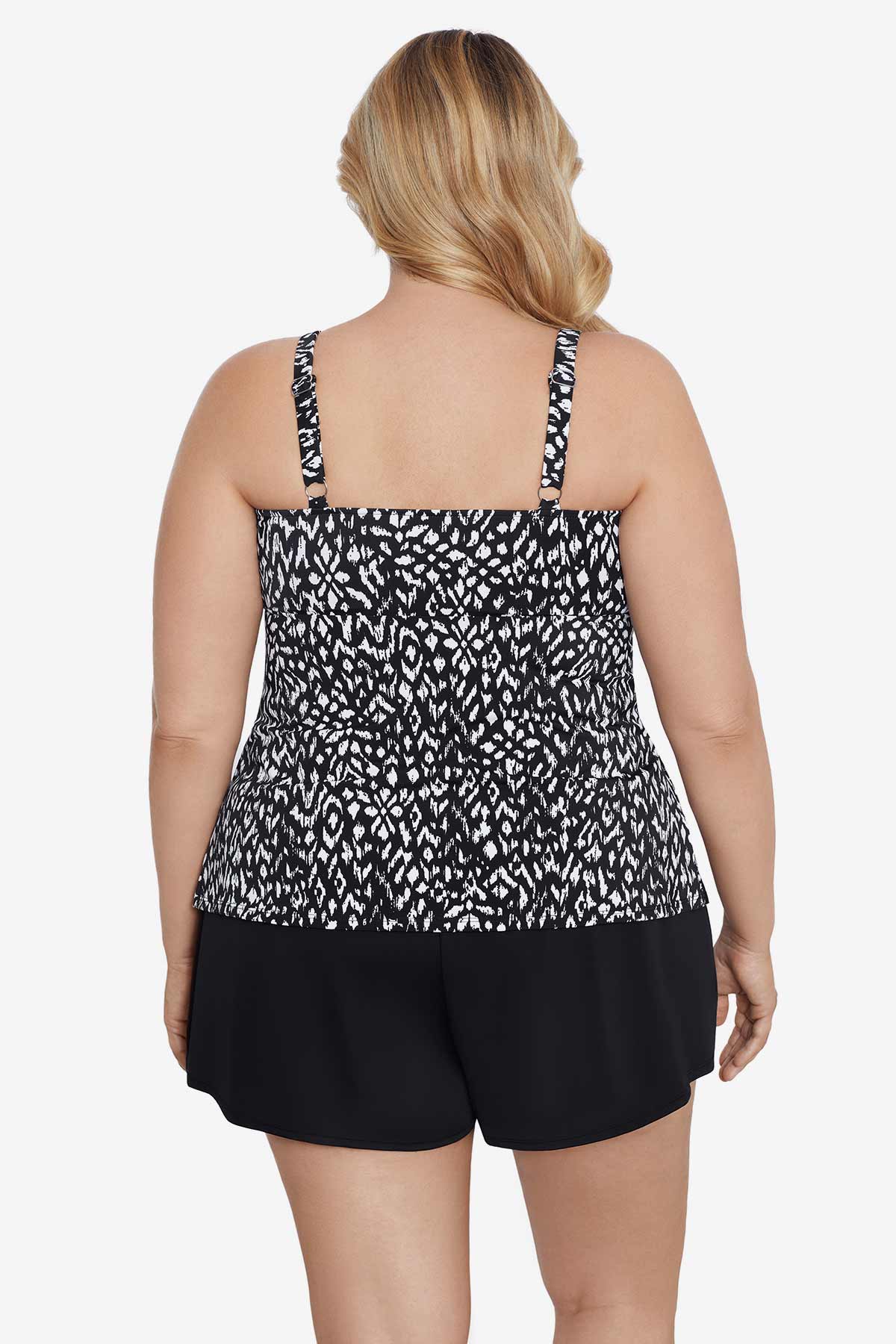 Woman turned away wearing a black and white scaley printed tiered tankini top