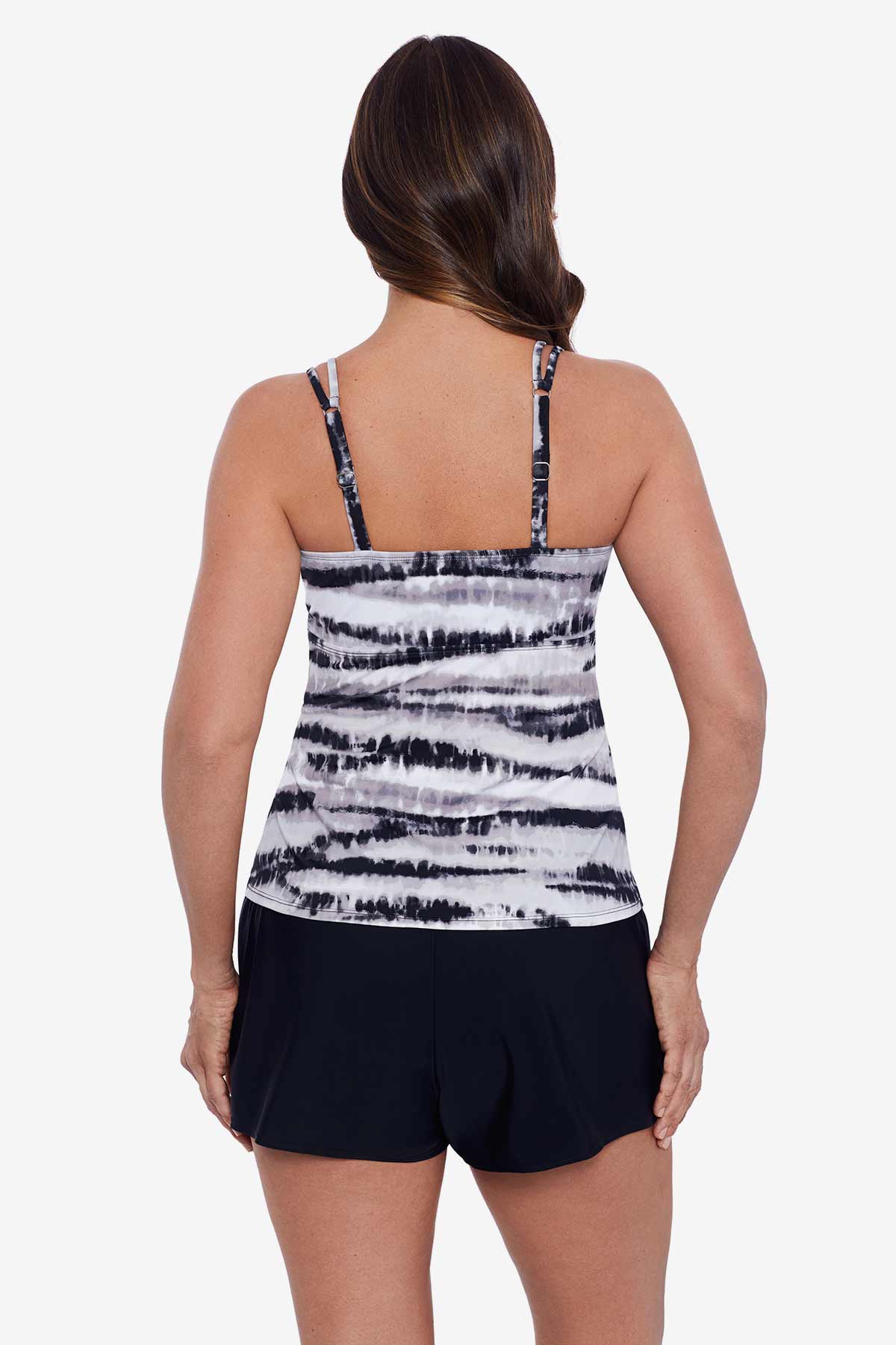Woman faced away wearing a black and white tie dye tankini top
