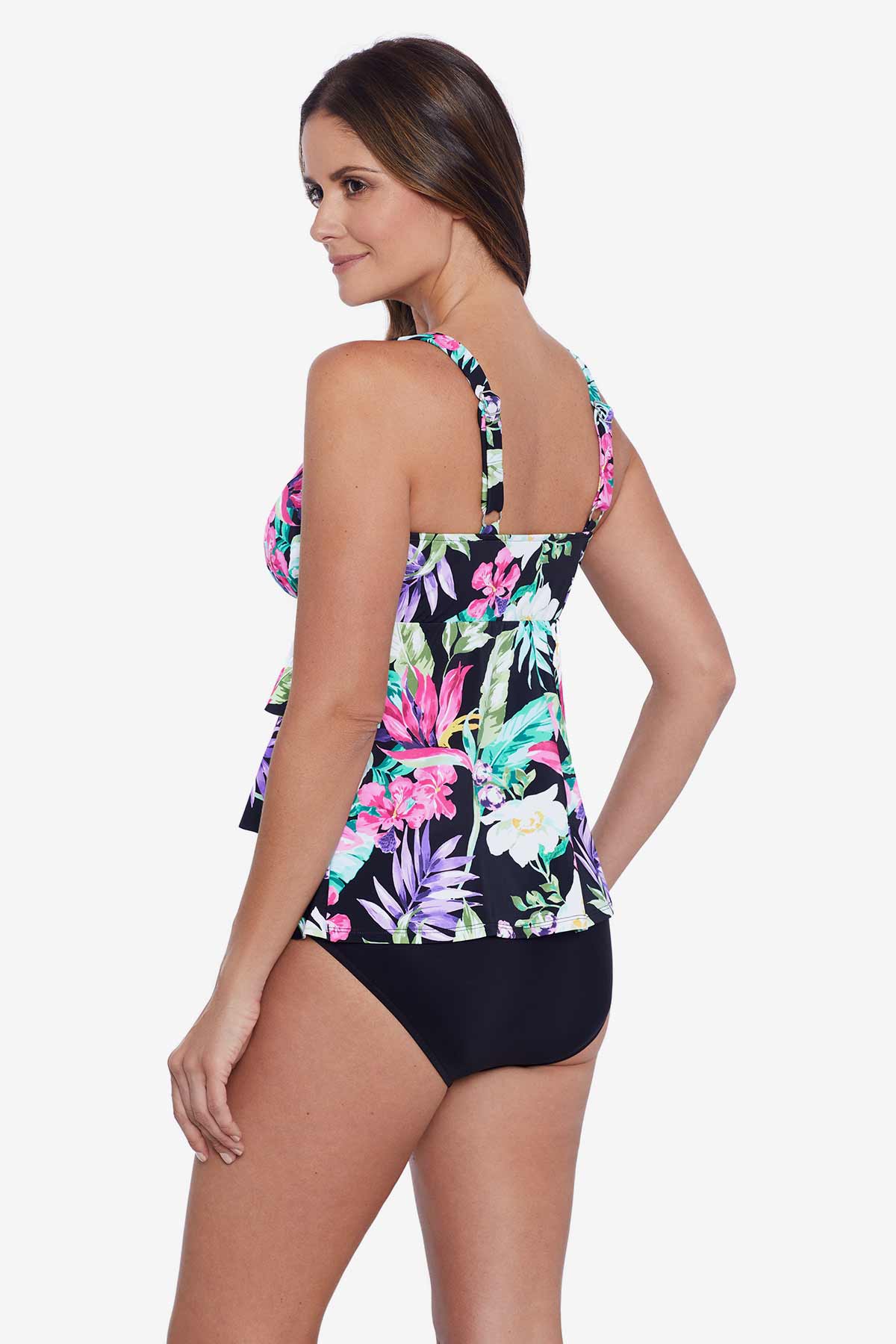 Woman faced left wearing a multicolored tropical printed ruffle tiered tankini top