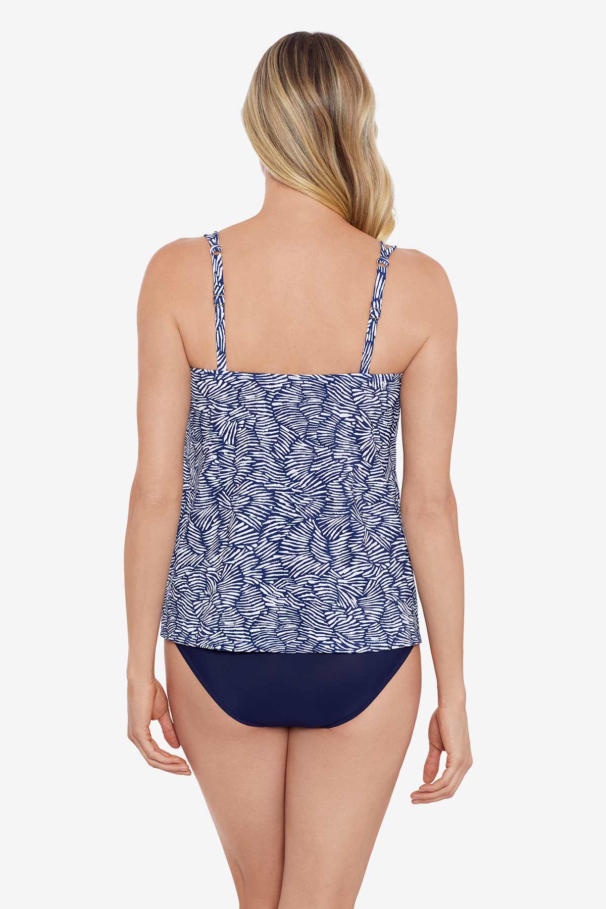 Woman faced away wearing a blue and white abstract pattern tankini top