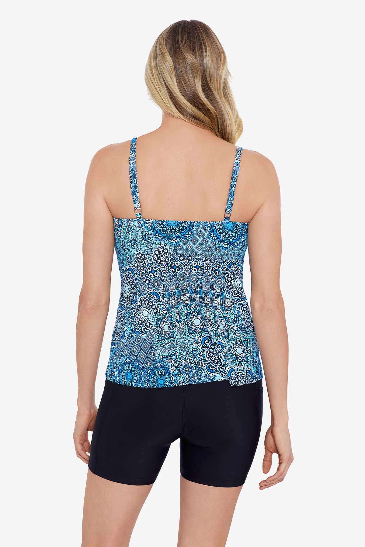 Woman faced away wearing a blue tile pattern side ring tankini top