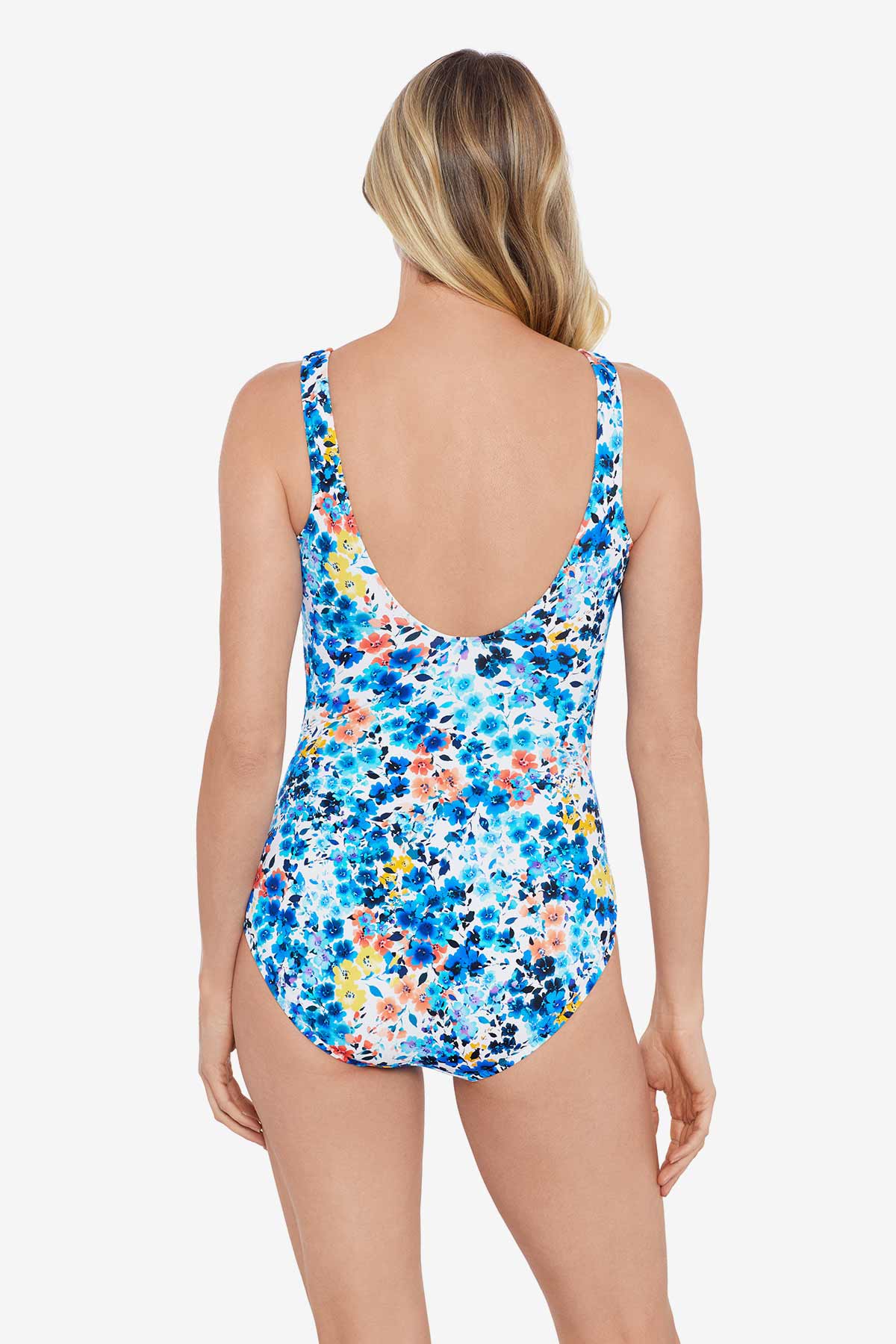 Woman faced away wearing a multicolored floral printed one-piece swimsuit