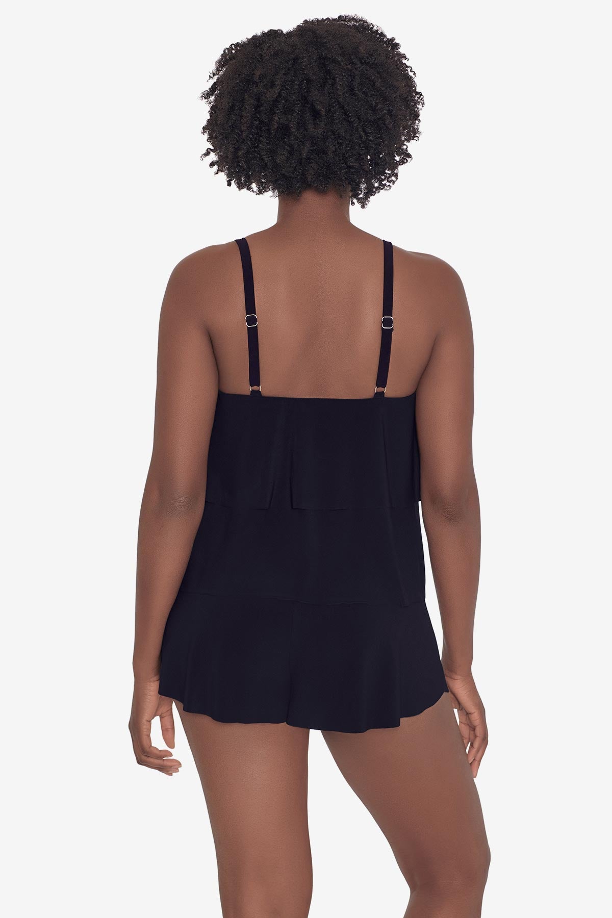 Woman faced away wearing a black tankini top with ruffles