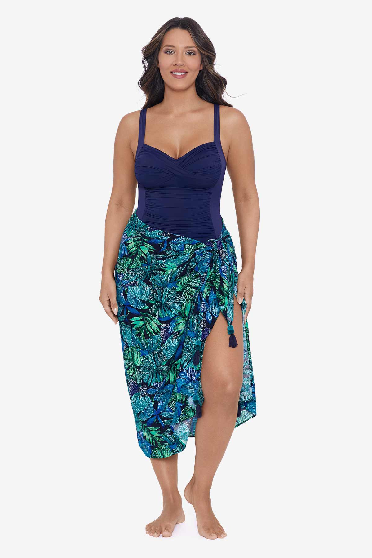 Woman wearing a palm leaf printed swim wrap cover up with tassels
