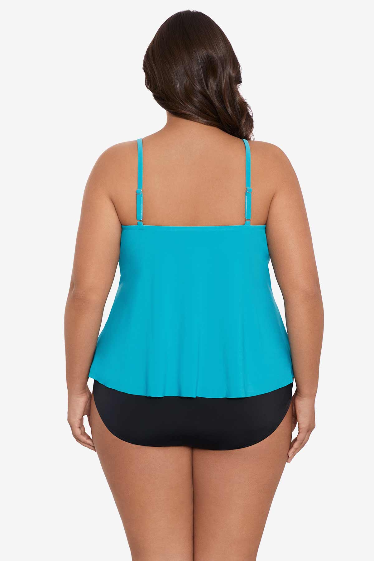 Woman turned away wearing a light blue tankini top with ruffles