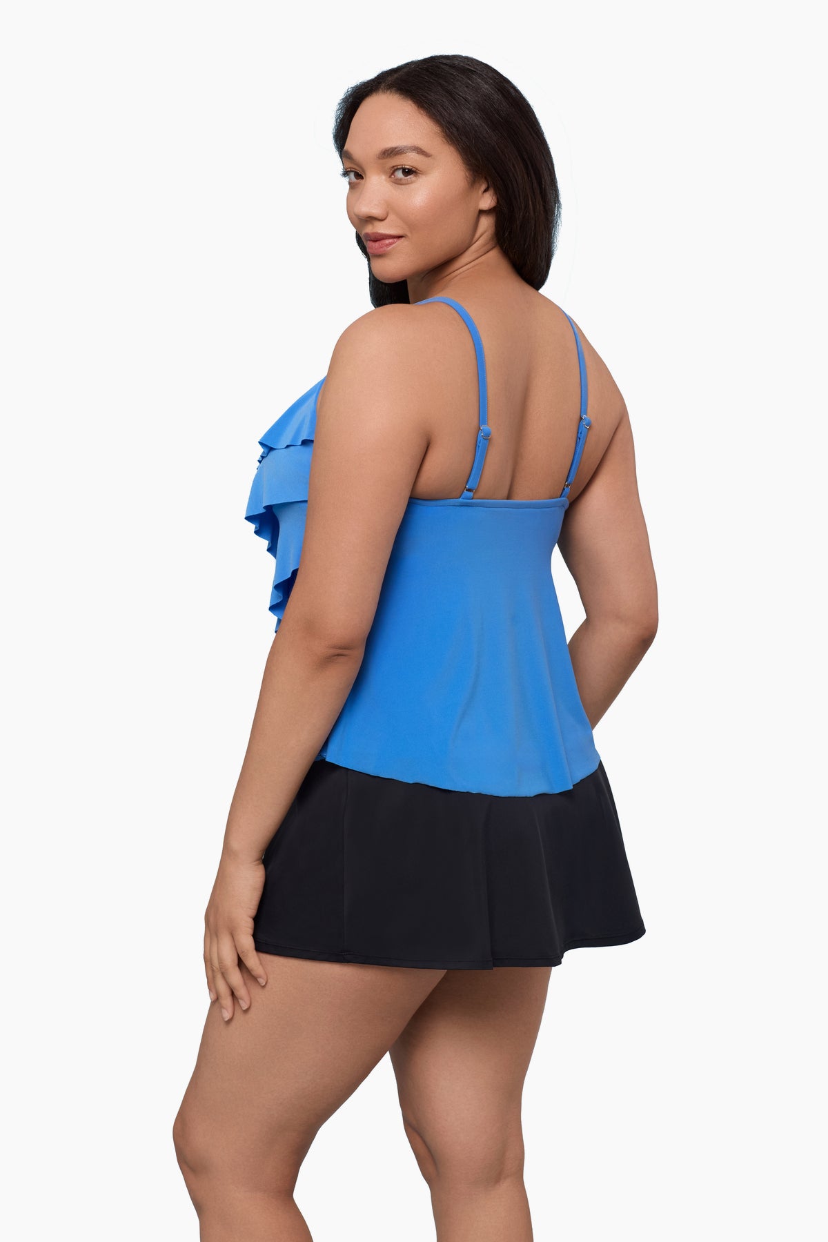 Woman turned left wearing a tiered tankini top in light blue