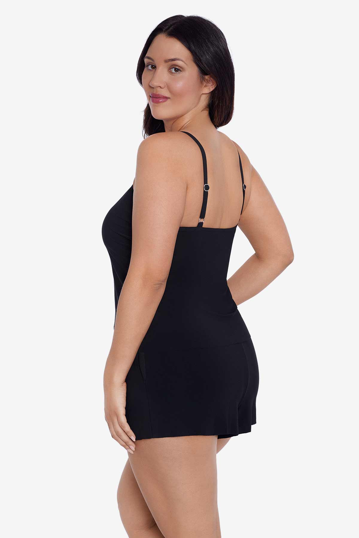 Woman turned left wearing a black swim romper