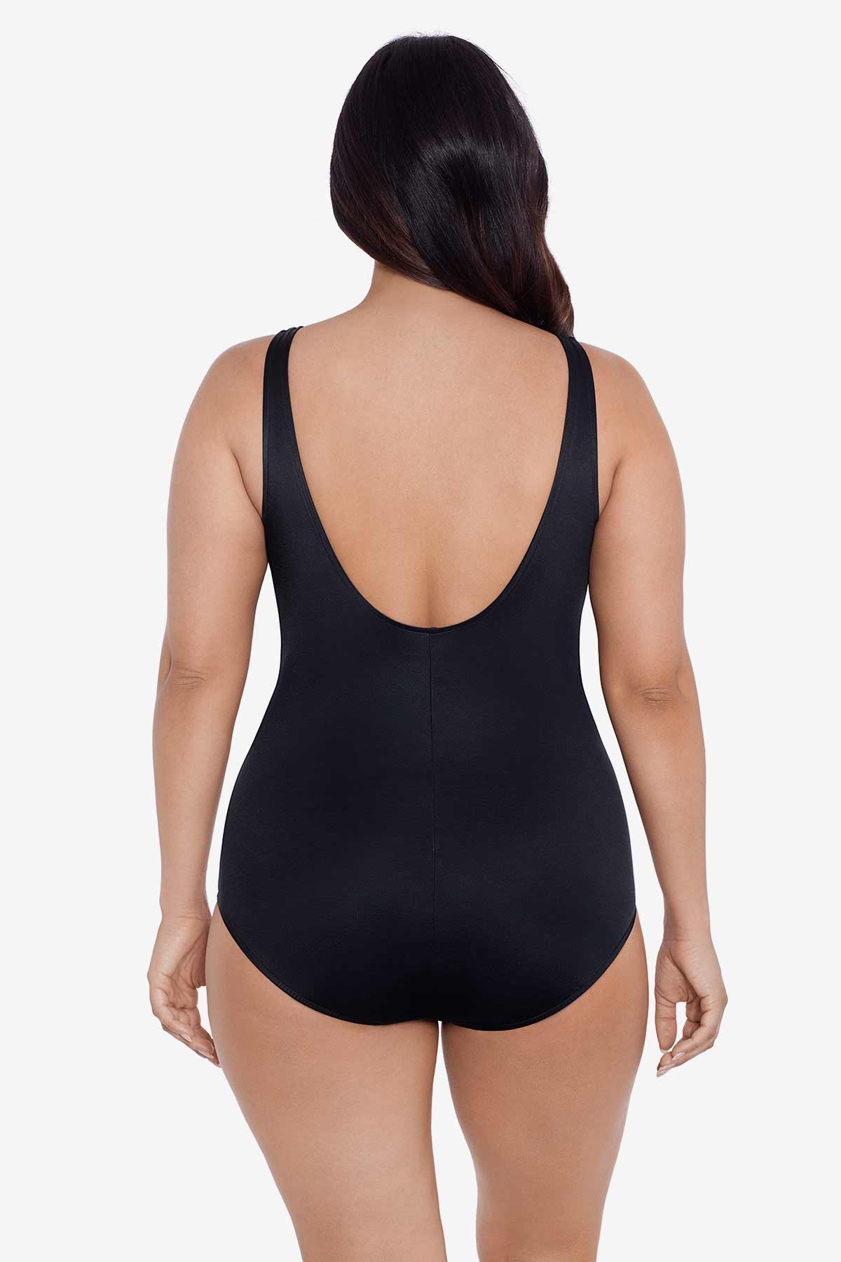 Woman faced away wearing a blue and maroon floral printed one-piece swimsuit