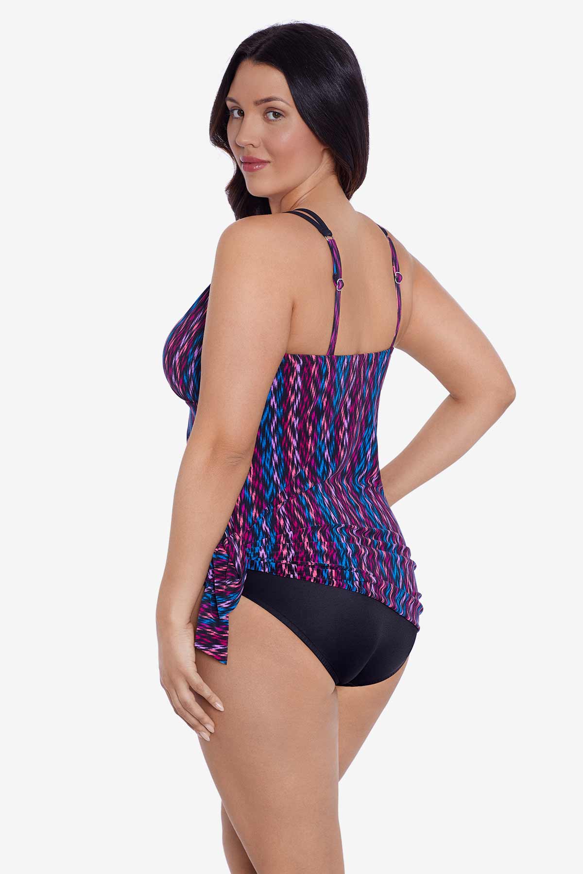 Woman turned left wearing a purple and blue stripey pattern swim dress tied at the side
