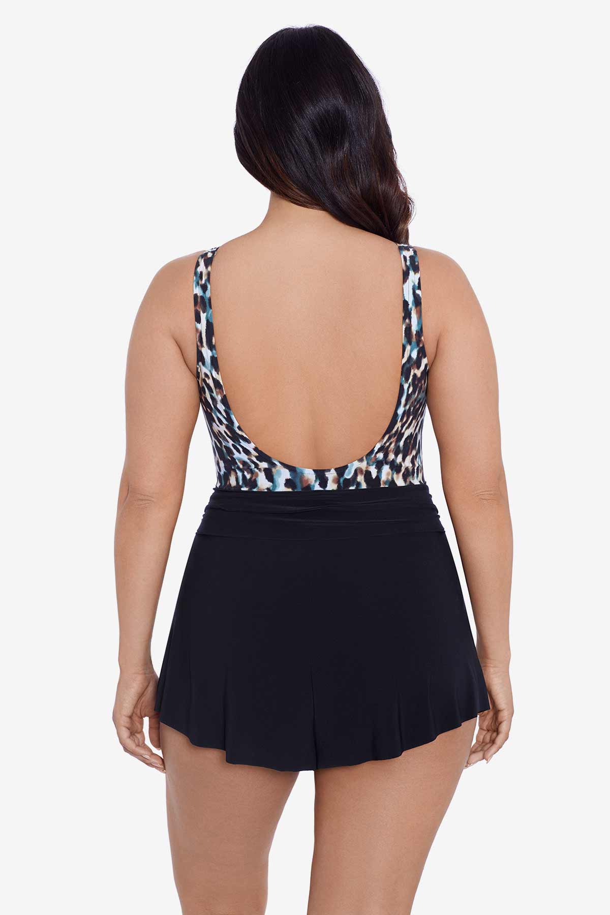 Woman faced away wearing a leopard printed swim romper with black shorts
