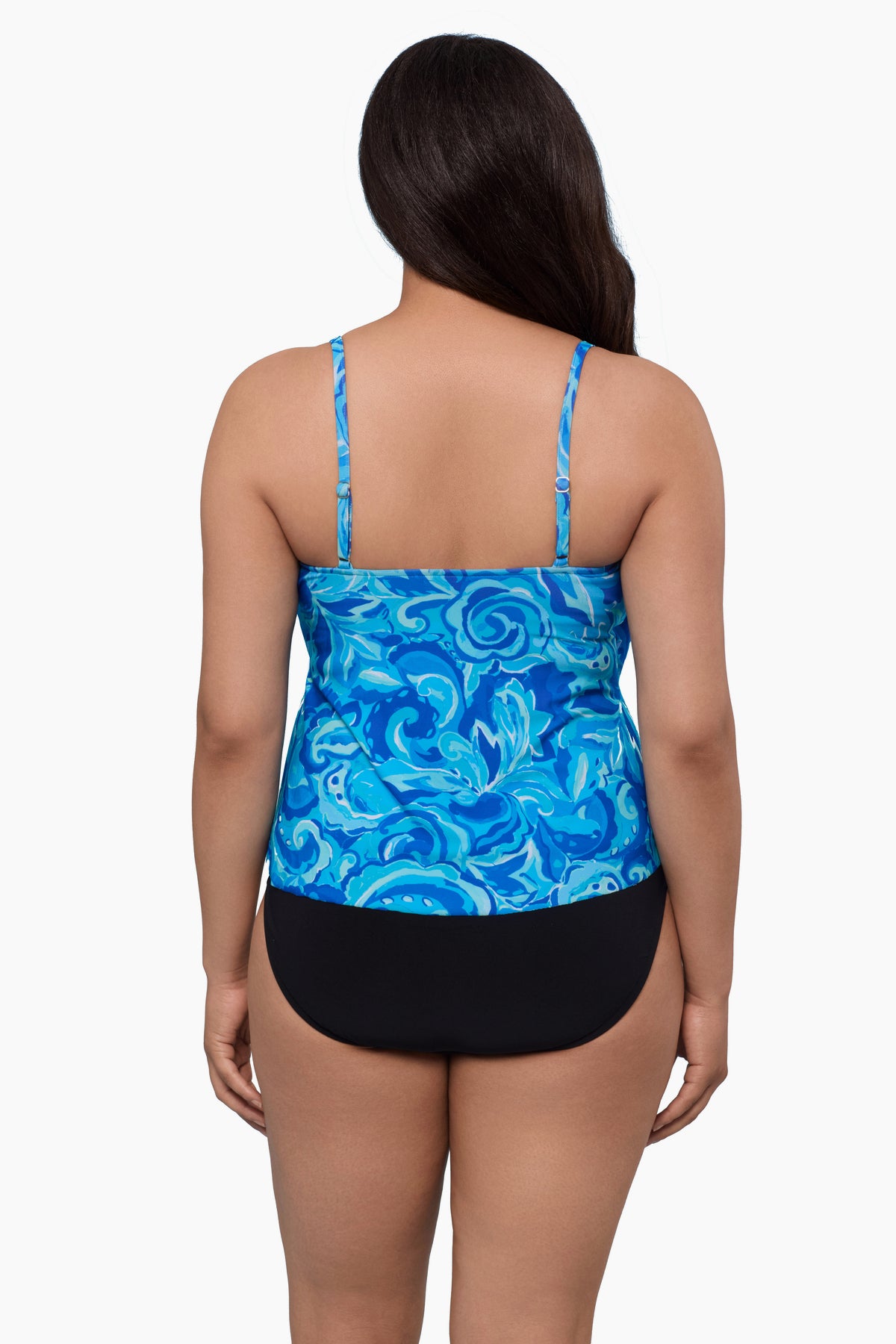 Woman turned away wearing a tankini top with an abstract blue pattern