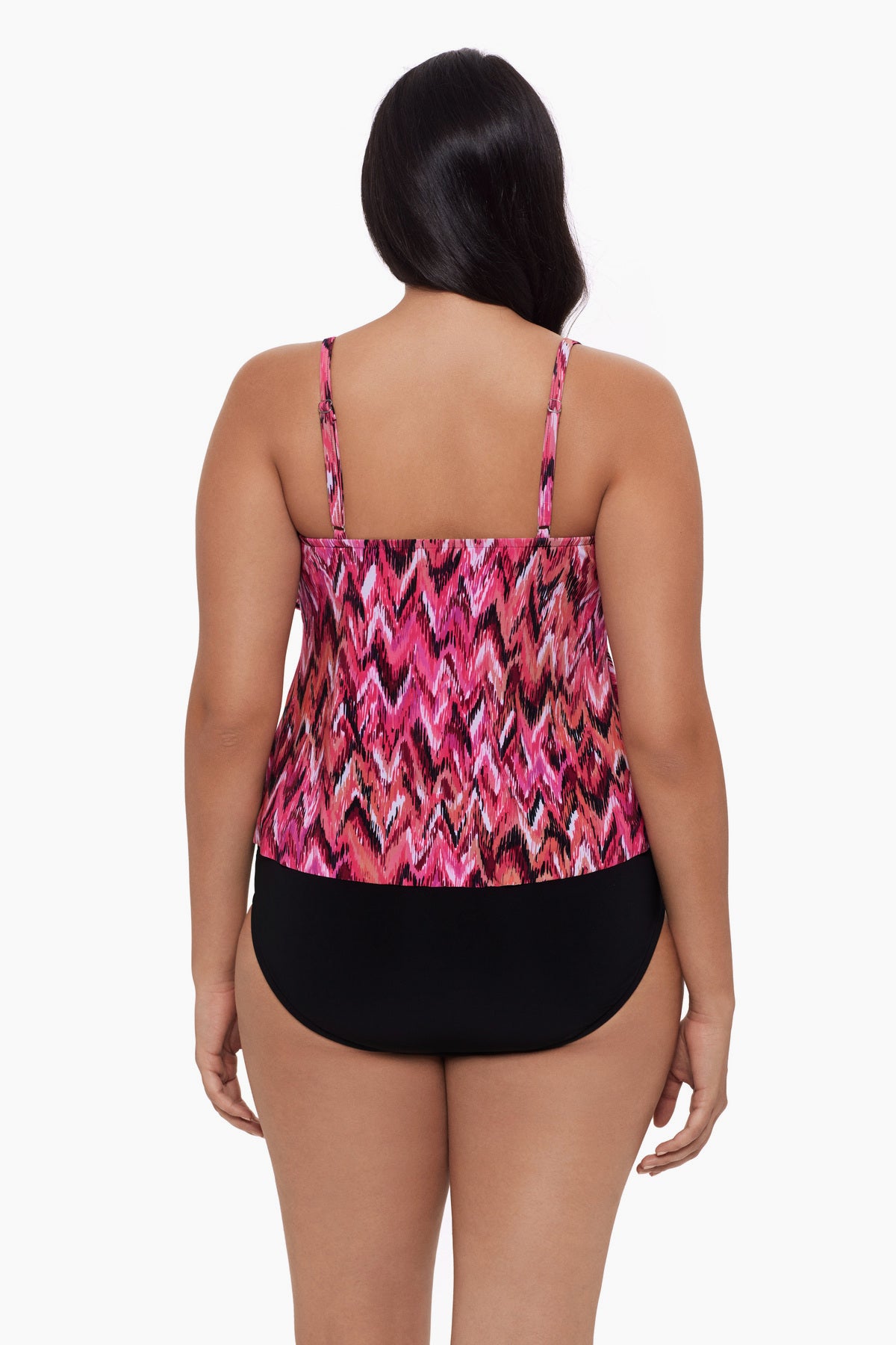 Woman turned away wearing a tankini top with an abstract pink pattern