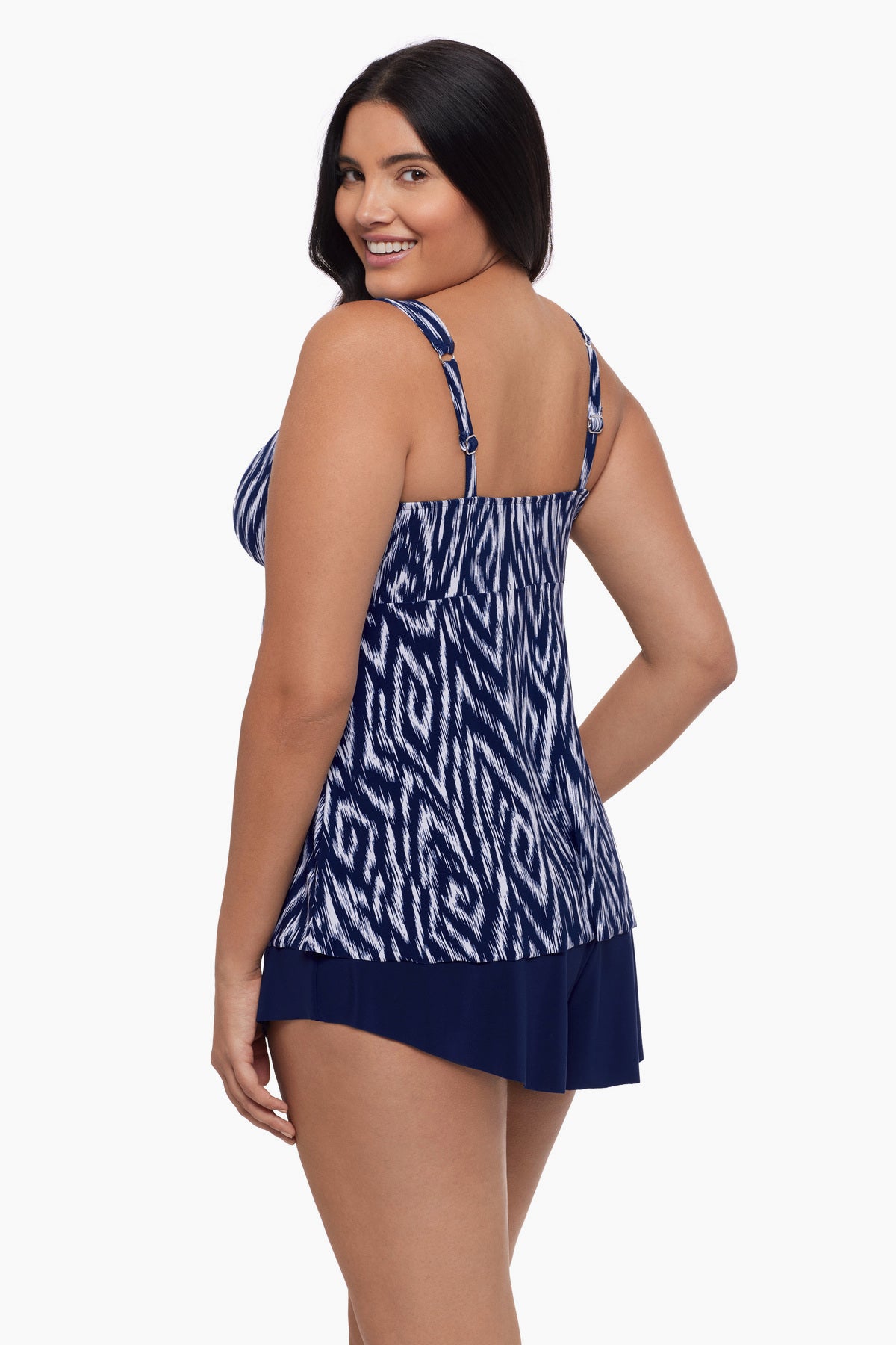 Woman turned left wearing a tankini top with an abstract blue and white print