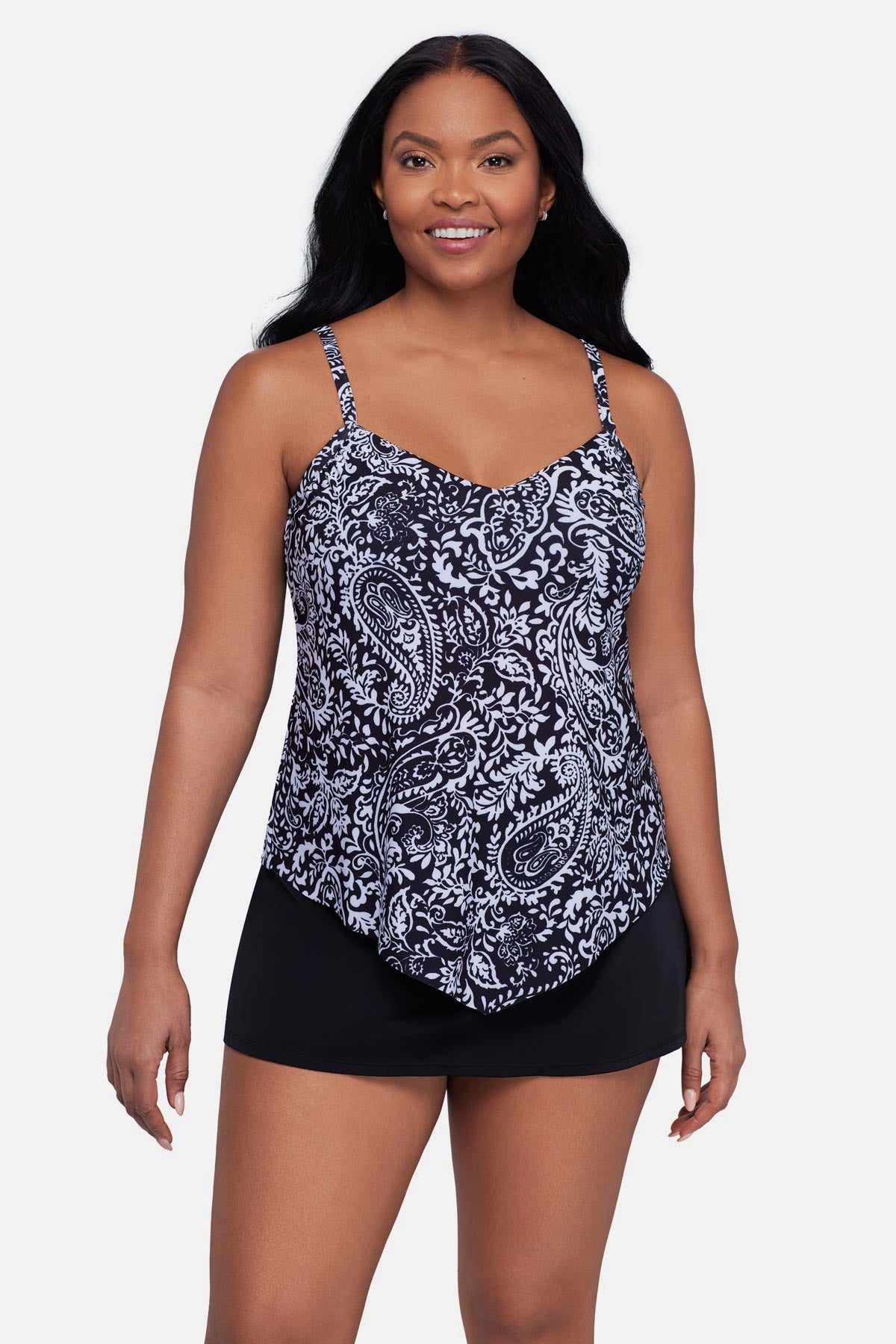 Woman wearing a black and white paisley printed tankini top