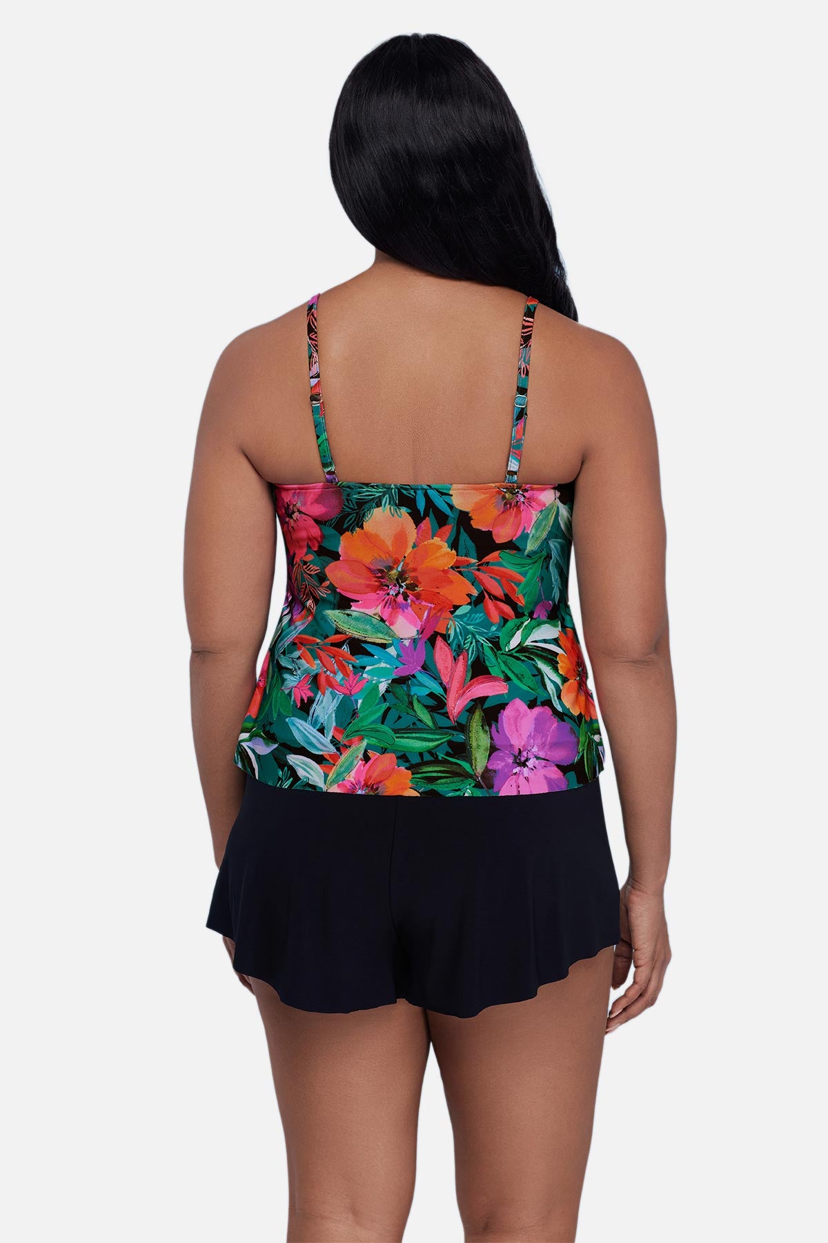 Woman turned away wearing a multicolor floral and leaf print tankini top