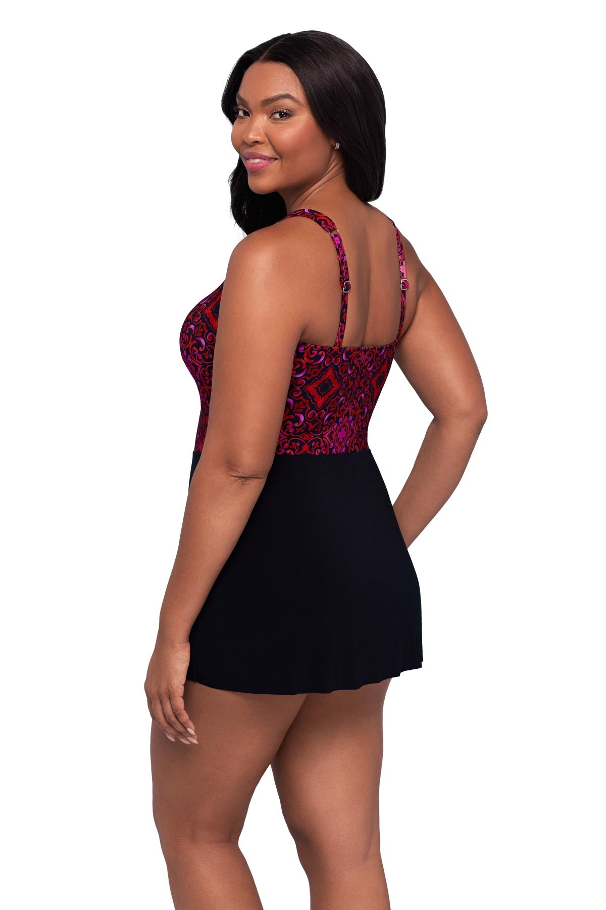 Woman turned left wearing a red and purple tile pattern swim dress
