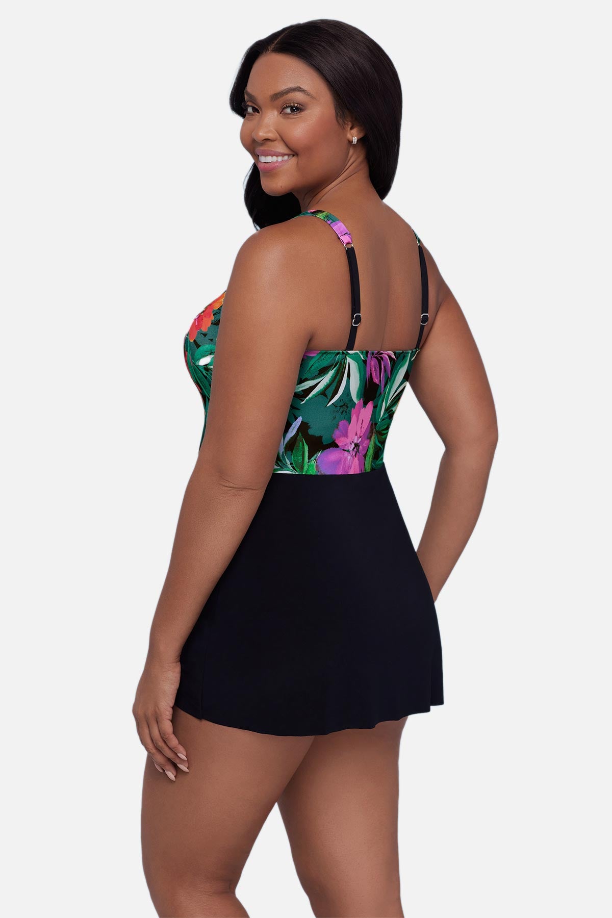Woman turned left wearing a multicolor floral and leaf printed swim dress