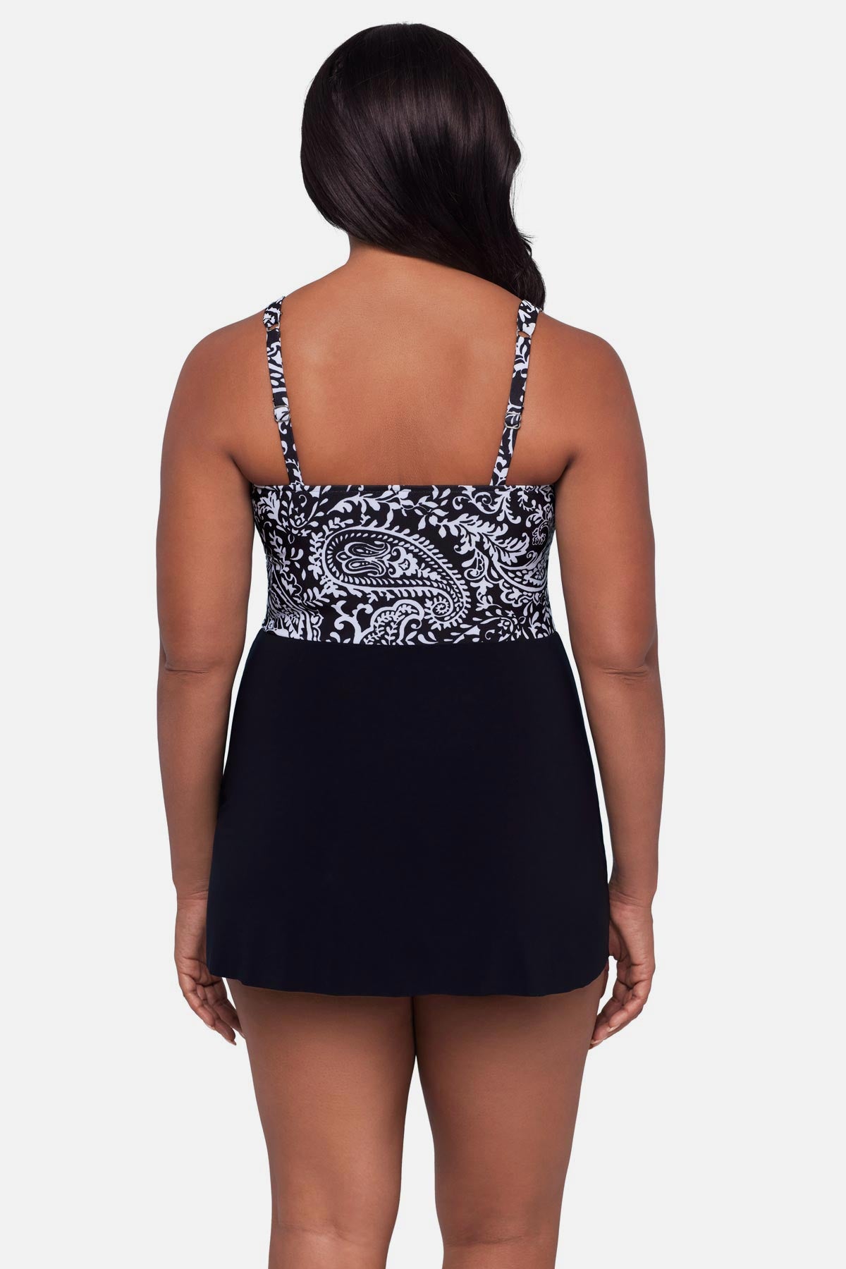 Woman turned away wearing a black and white paisley printed swim dress