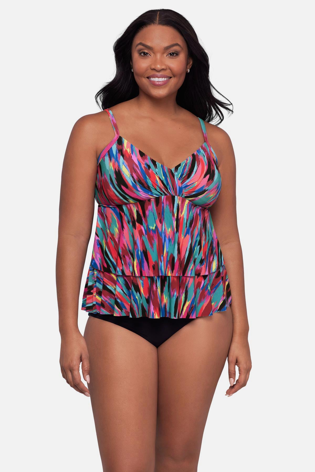 Woman wearing an abstract multicolored printed tankini top with ruffles