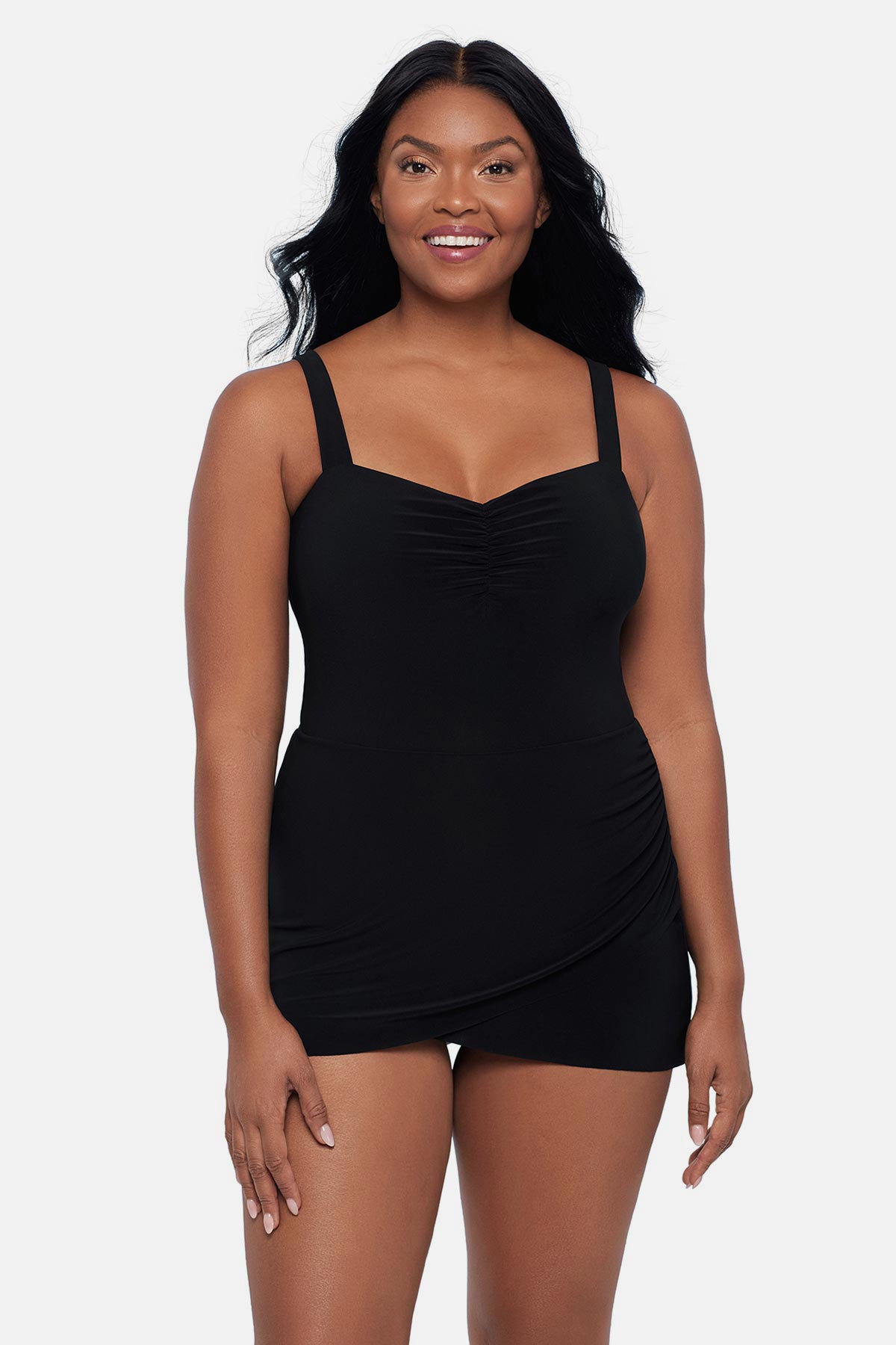 Woman wearing a black swim dress with a sweetheart neckline