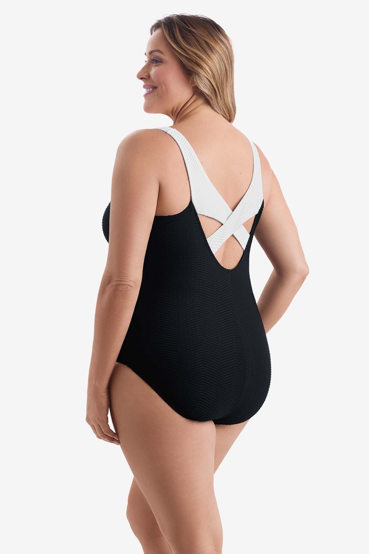 Woman turned left wearing a black one-piece swimsuit with white on the X back