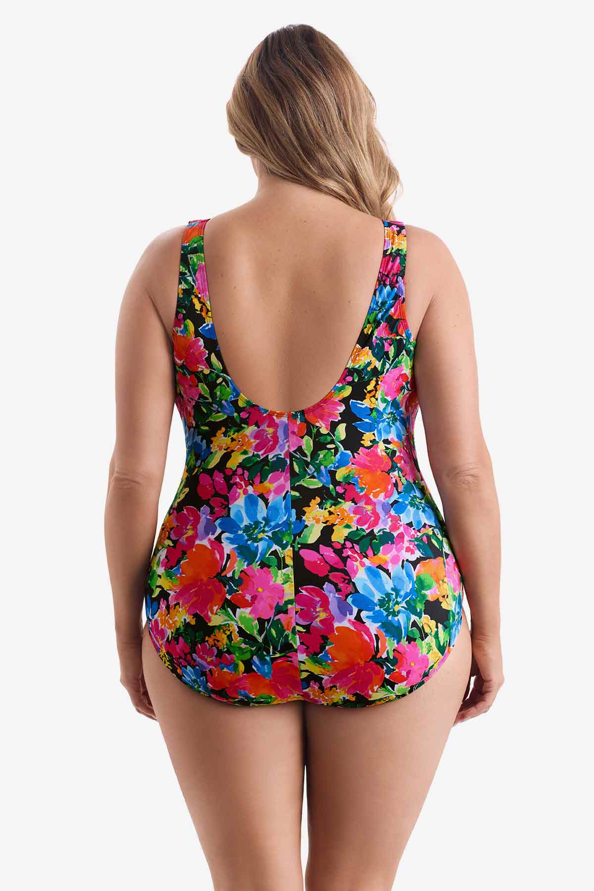Woman turned away wearing a multicolored floral one-piece swimsuit