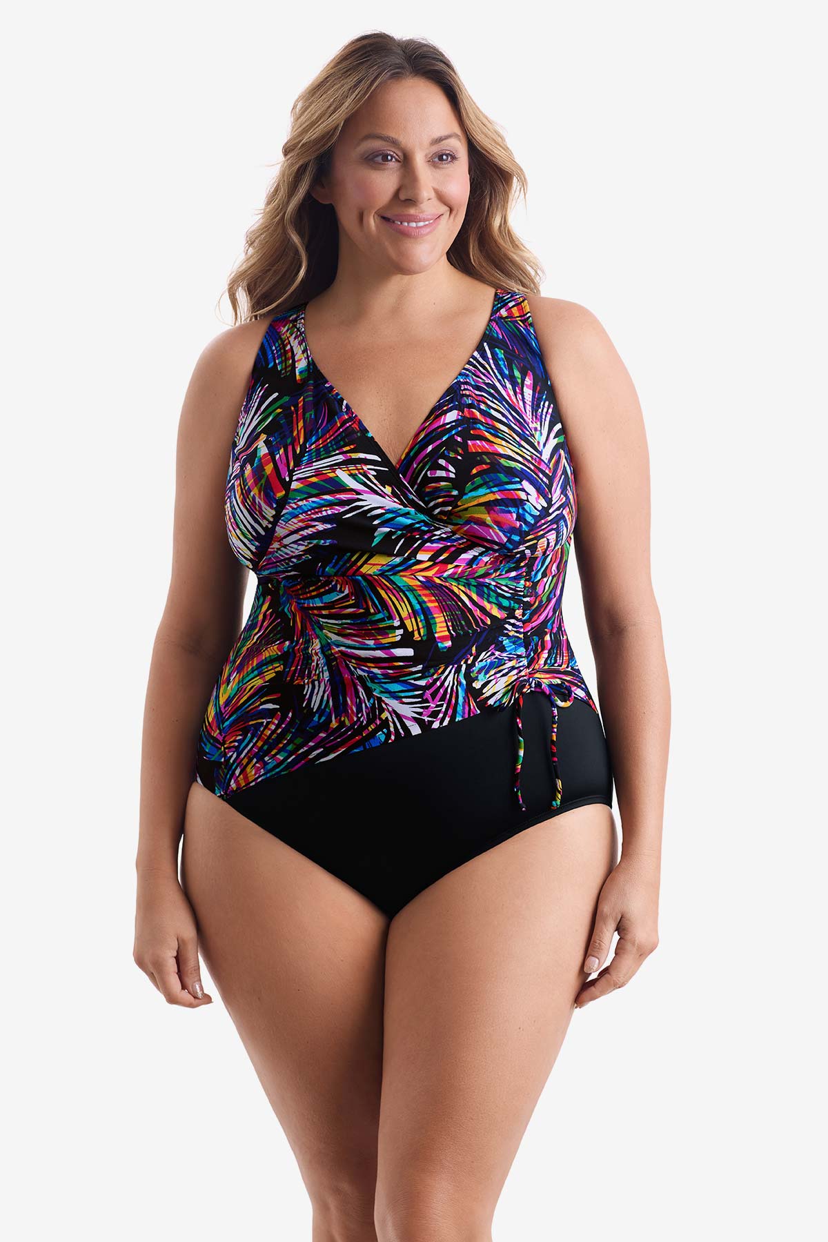 Woman wearing a rainbow abstract printed one-piece swimsuit with side tie