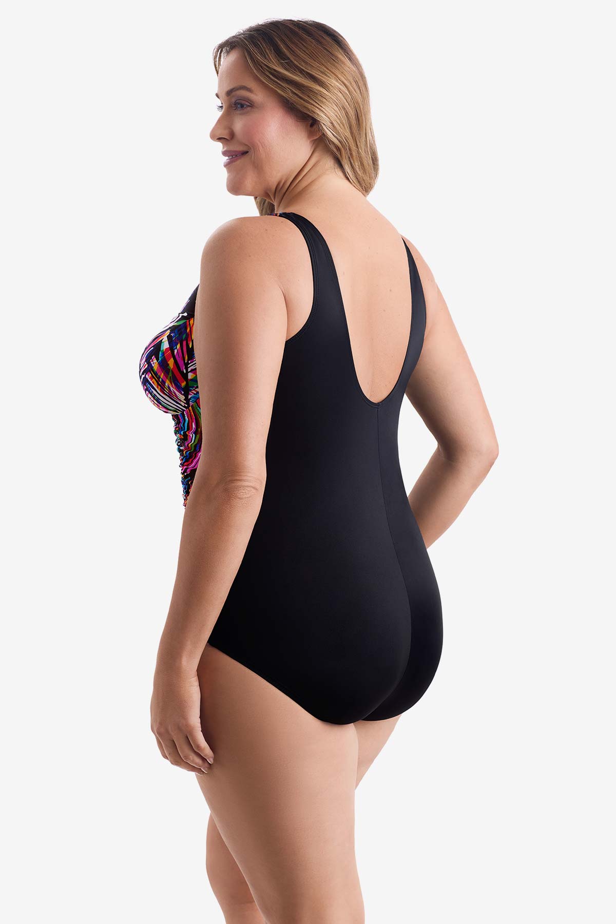 Woman turned left wearing a rainbow abstract printed one-piece swimsuit