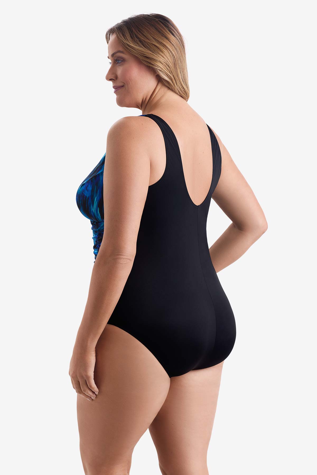 Woman faced left wearing a black and blue feathered pattern one-piece swimsuit