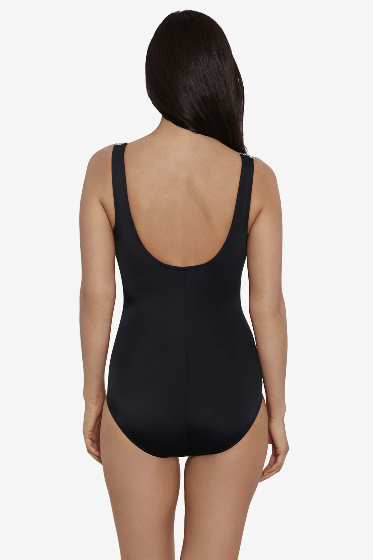 Woman turned away wearing a black and white zig zag pattern on the bust one-piece swimsuit