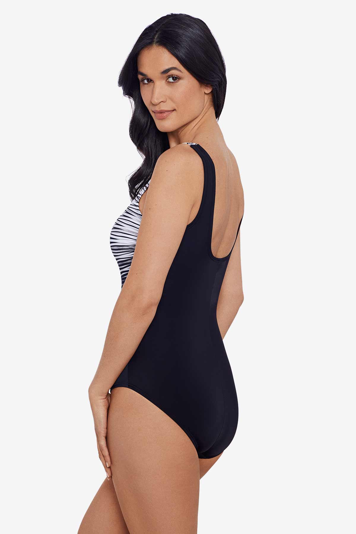 Woman turned left wearing a black and white stripey pattern one-piece swimsuit