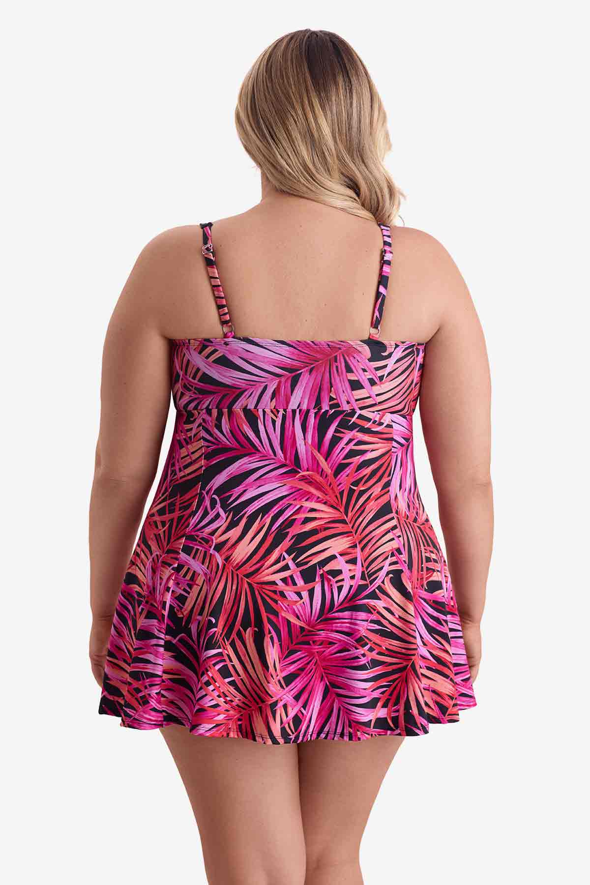 Woman faced away wearing a pink palm leaf printed swim dress
