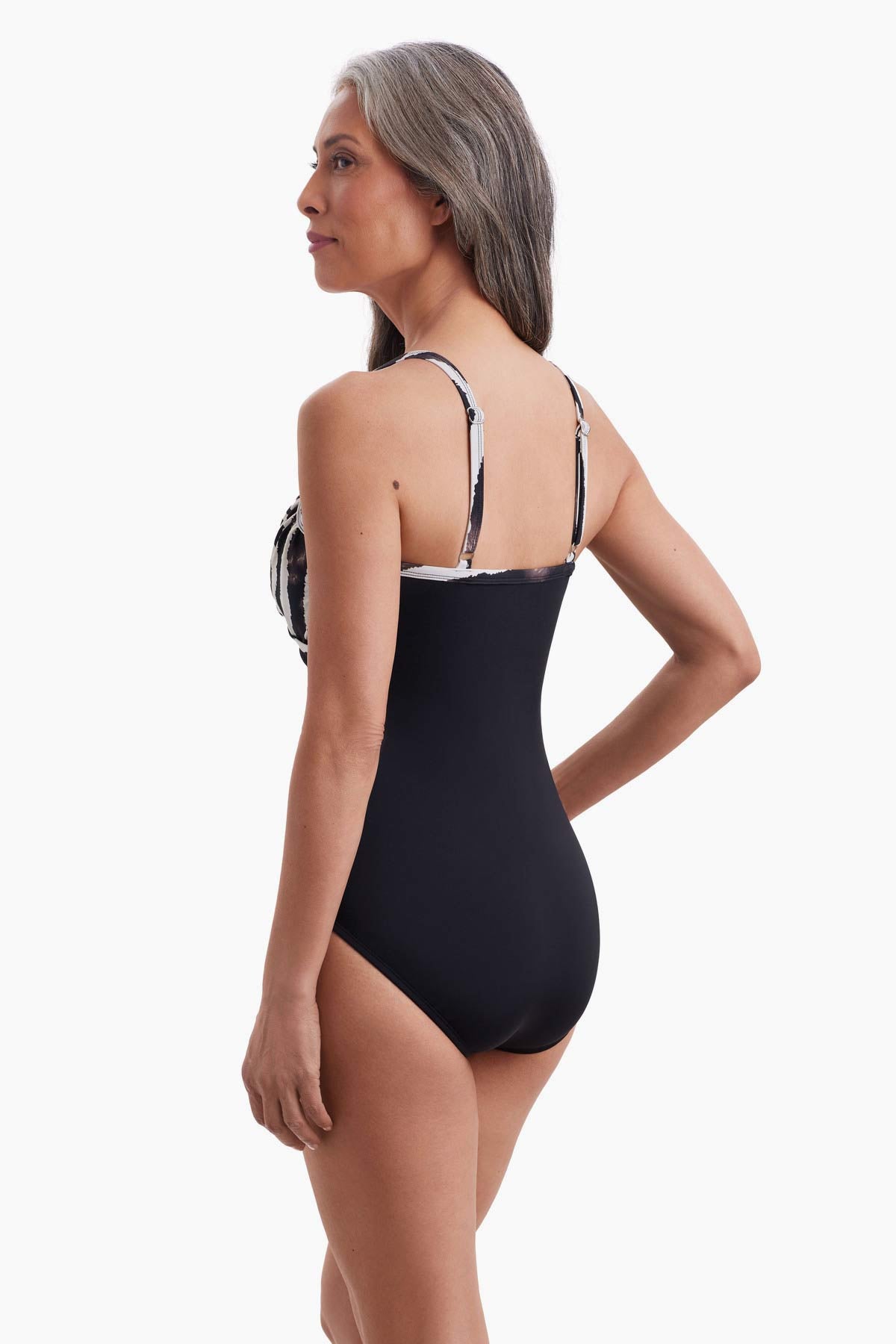 Woman turned left to show detail of one-piece swimsuit
