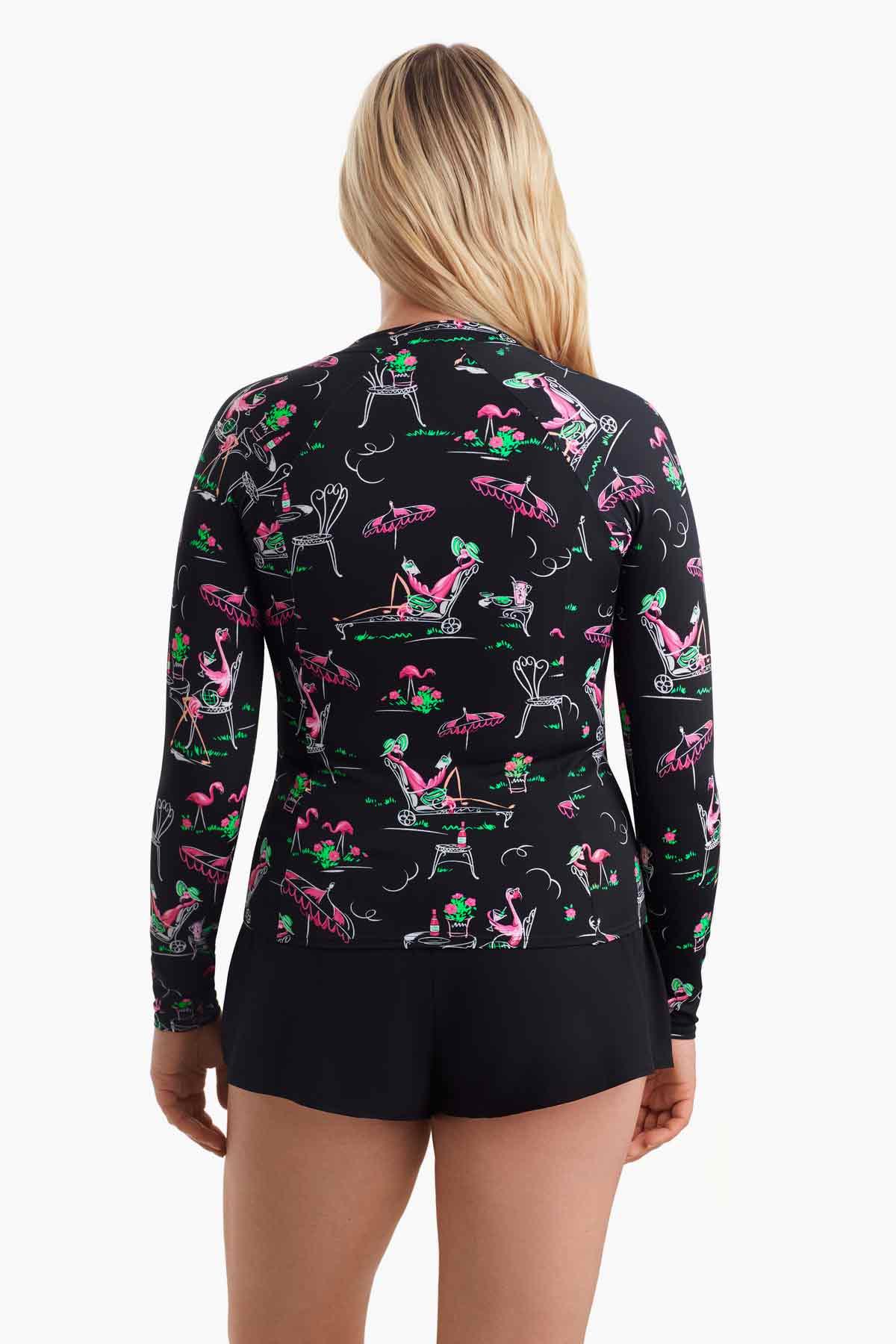 Woman faced away wearing a flamingo printed sun shirt