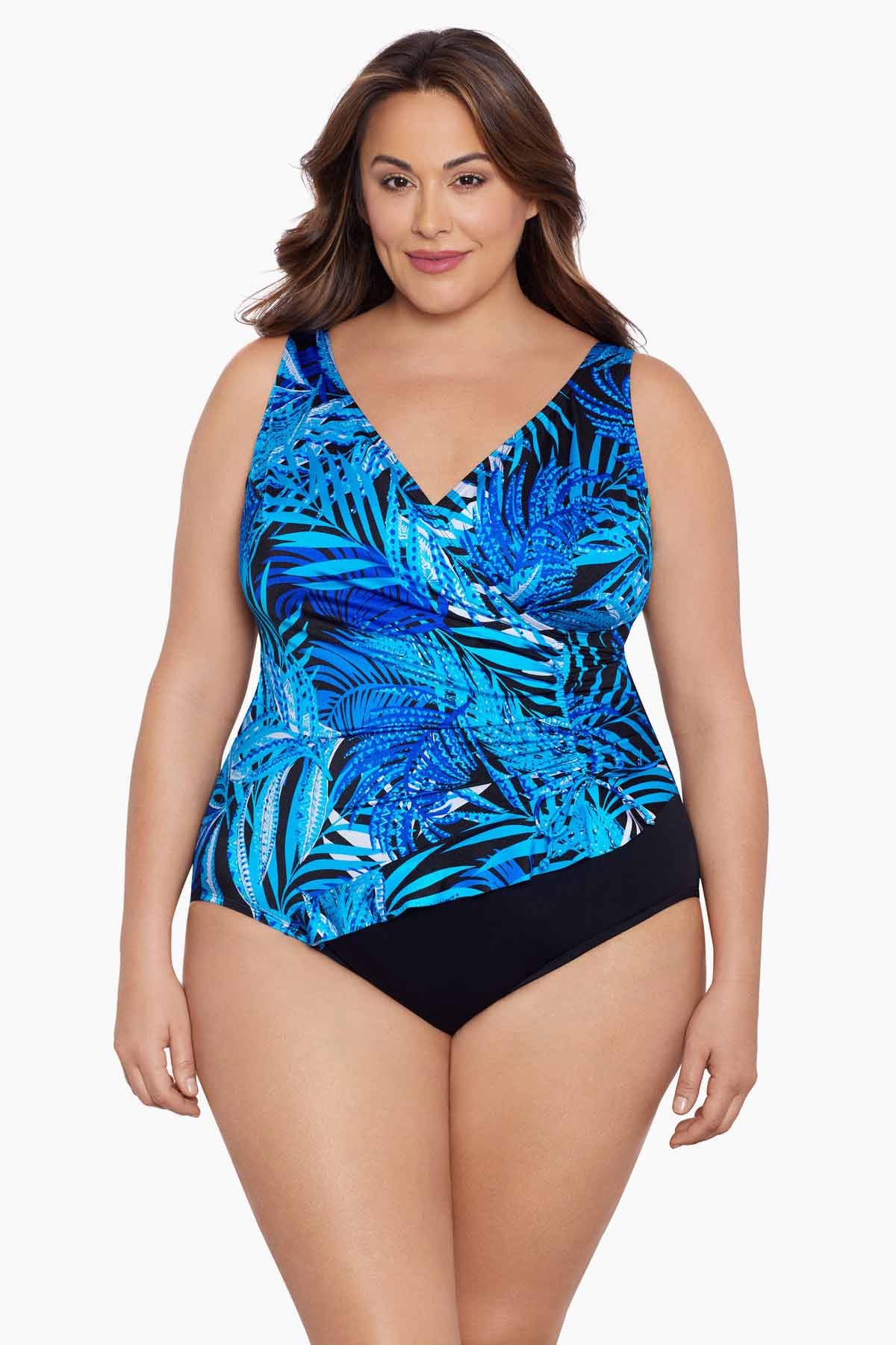 Woman wearing a blue palm leaf printed one-piece swimsuit