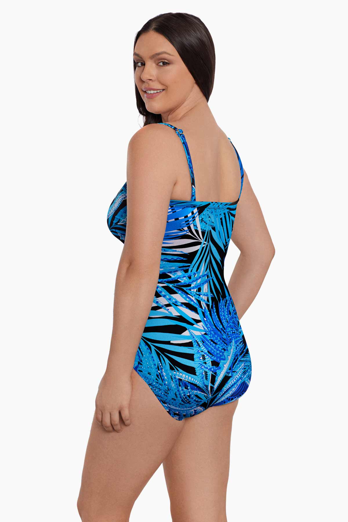 Woman turned left wearing a blue palm leaf printed bandeau with straps one-piece swimsuit