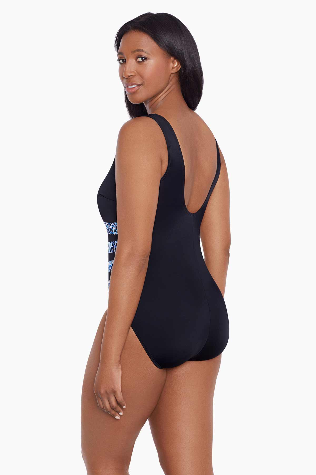 Woman turned left wearing a dotted print four streak one-piece swimsuit