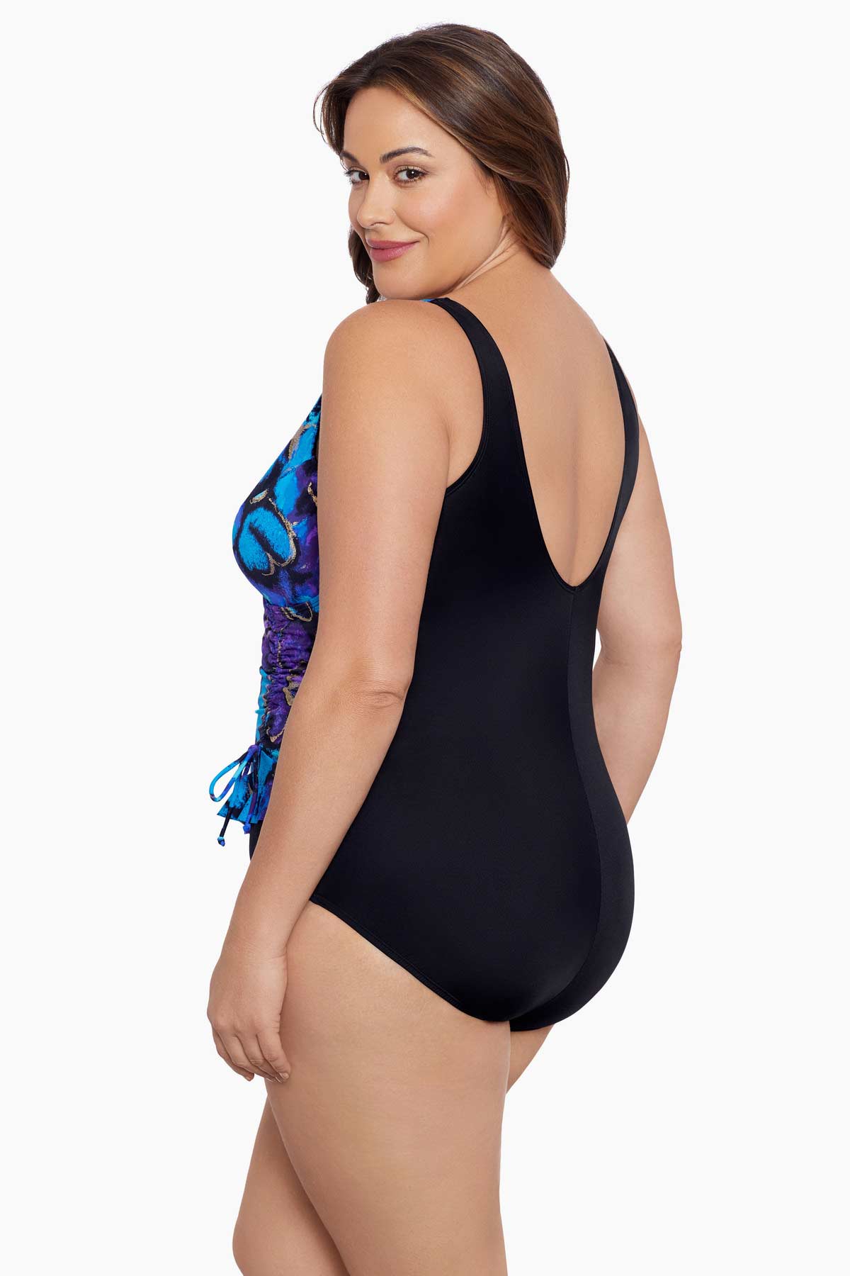 Woman turned left wearing a blue and gold floral printed one-piece swimsuit