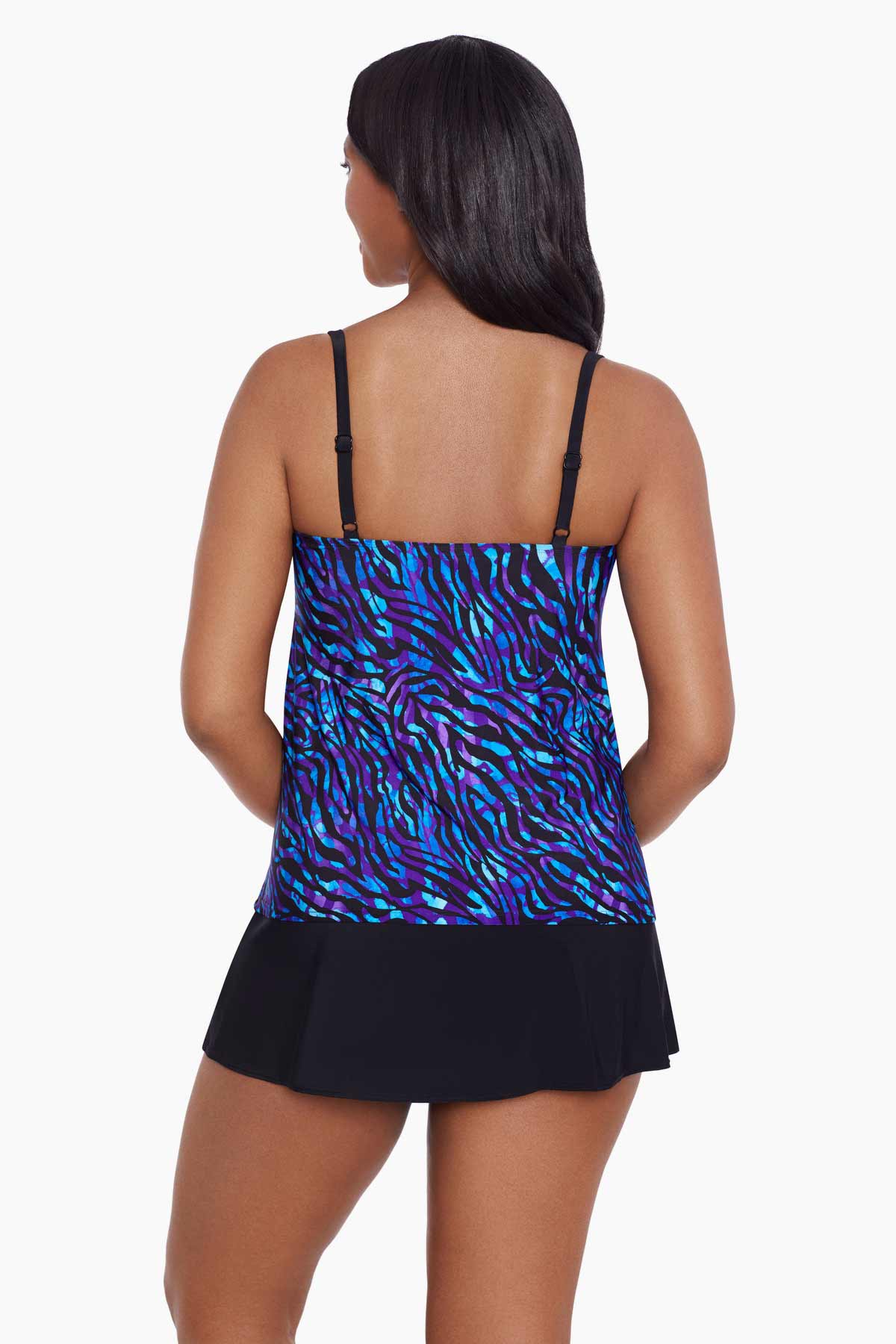 Woman turned away wearing a black and blue safari printed ruffled skirtini swimsuit