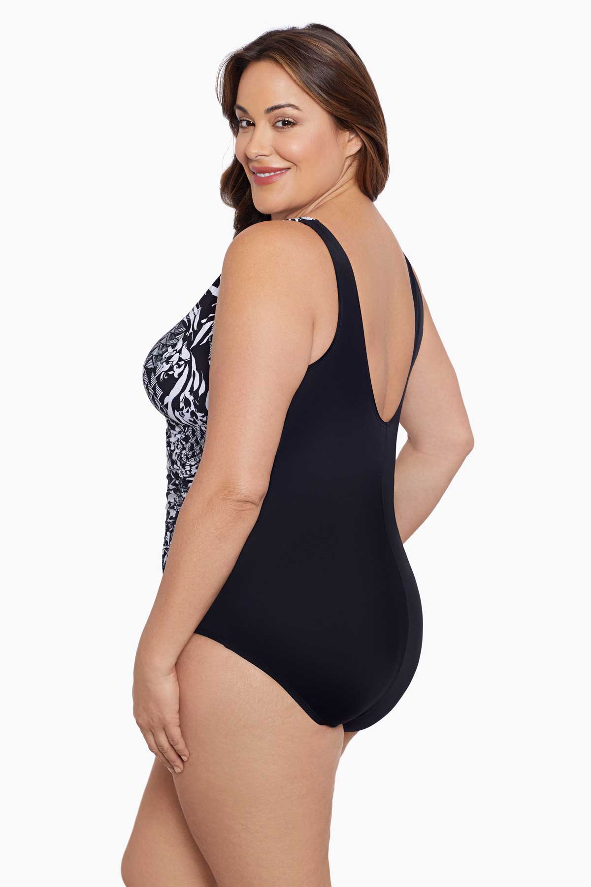 Woman turned left wearing a black and white geometric pattern one-piece swimsuit
