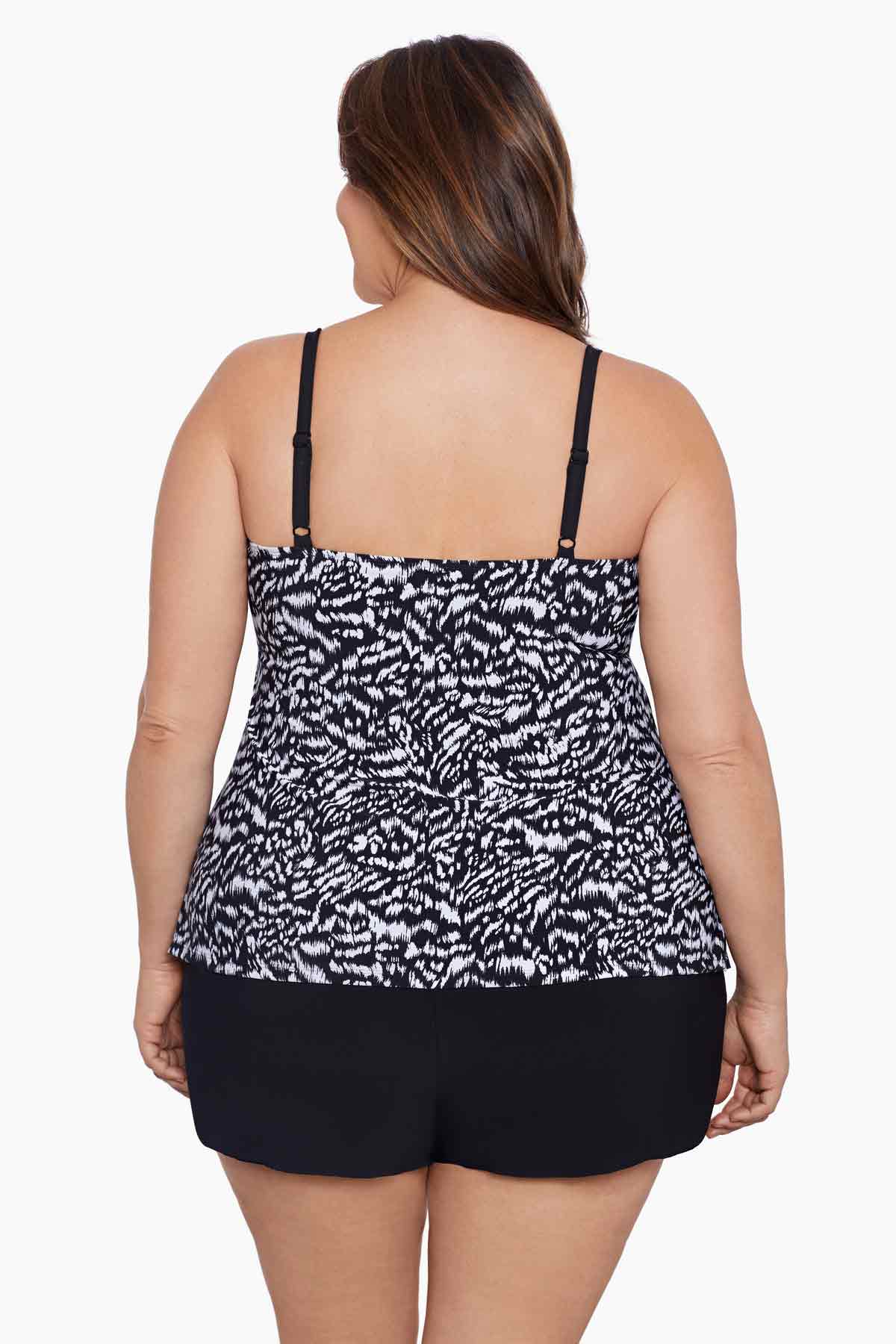 Woman faced away wearing a black and white abstract printed ruffle shortini