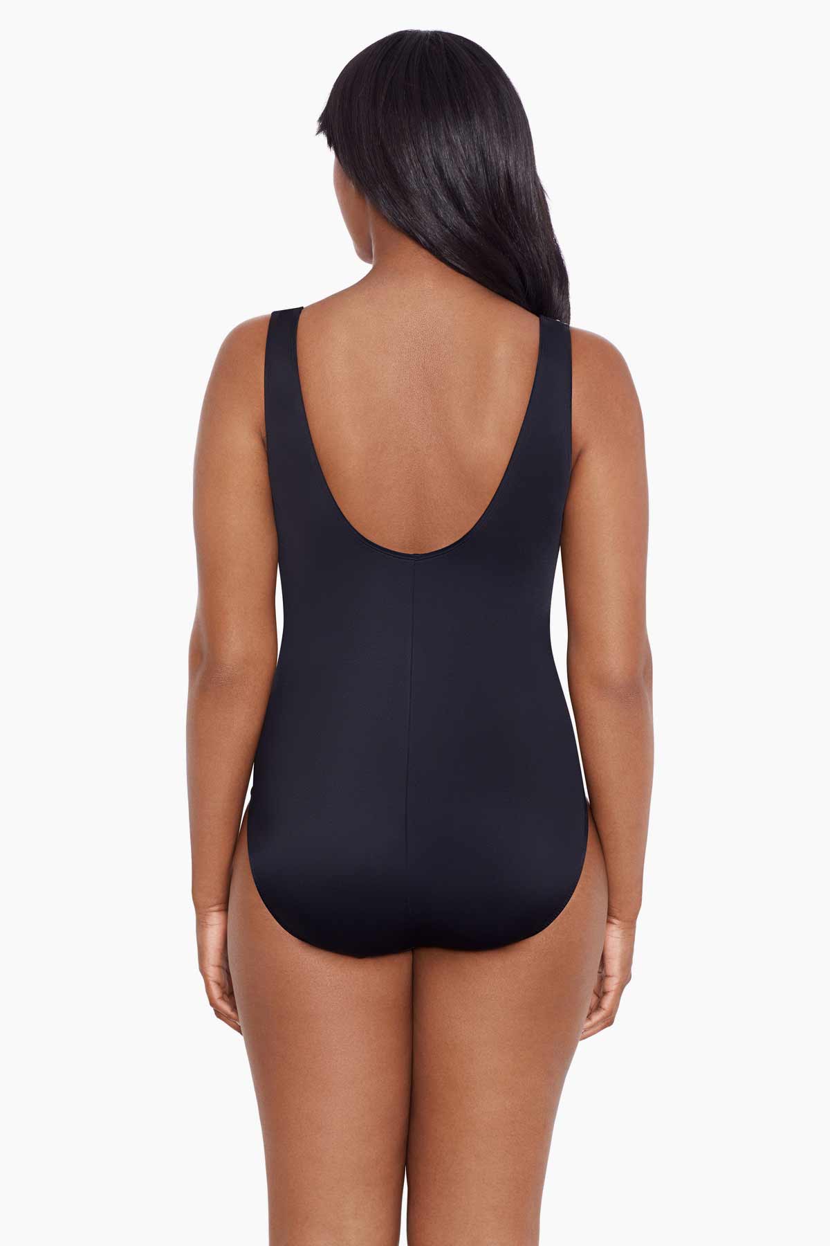 Woman faced away wearing a black and white abstract printed one-piece swimsuit with mesh cutout on the side