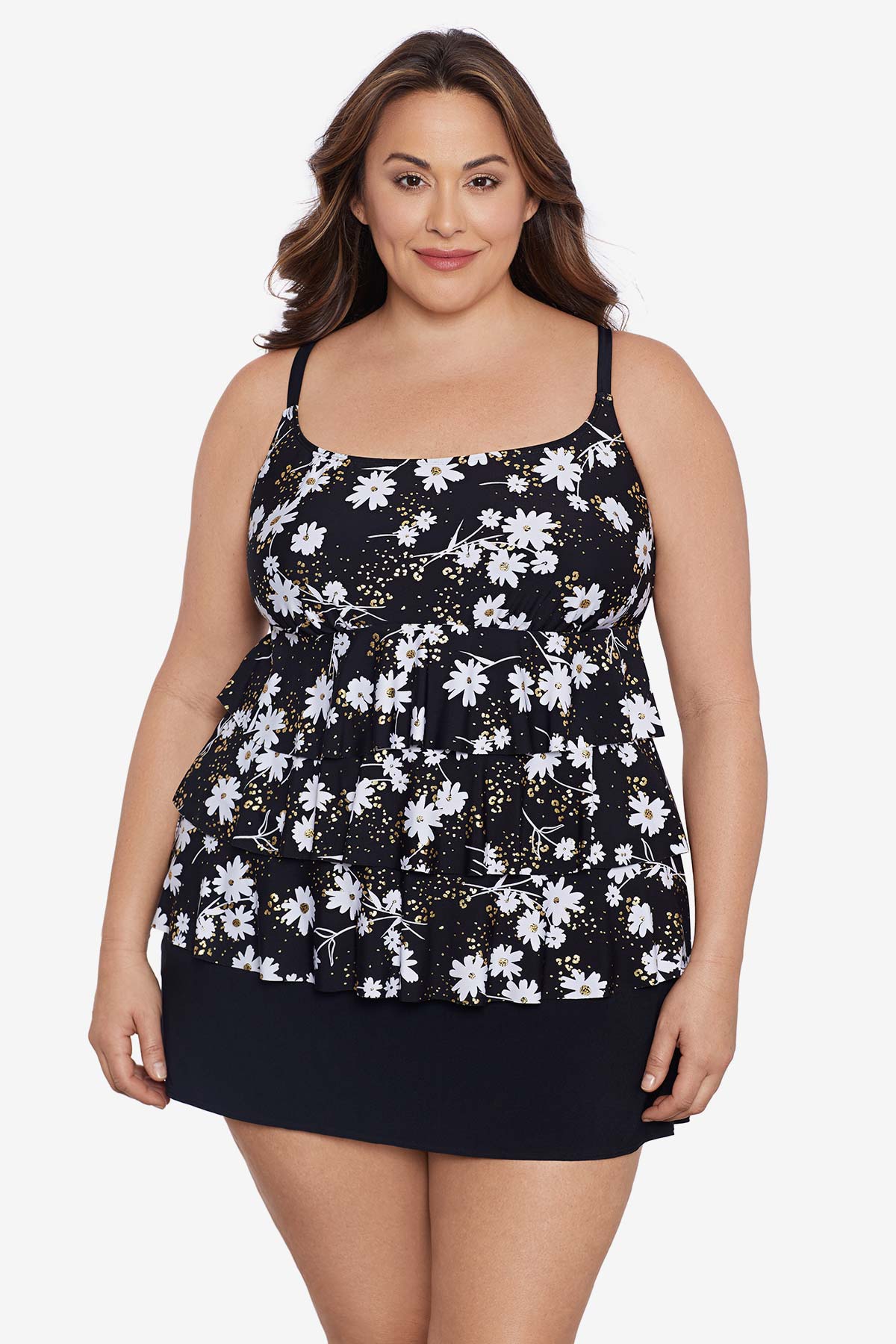 Woman wearing a small white flower printed black skirtini swimsuit with ruffles