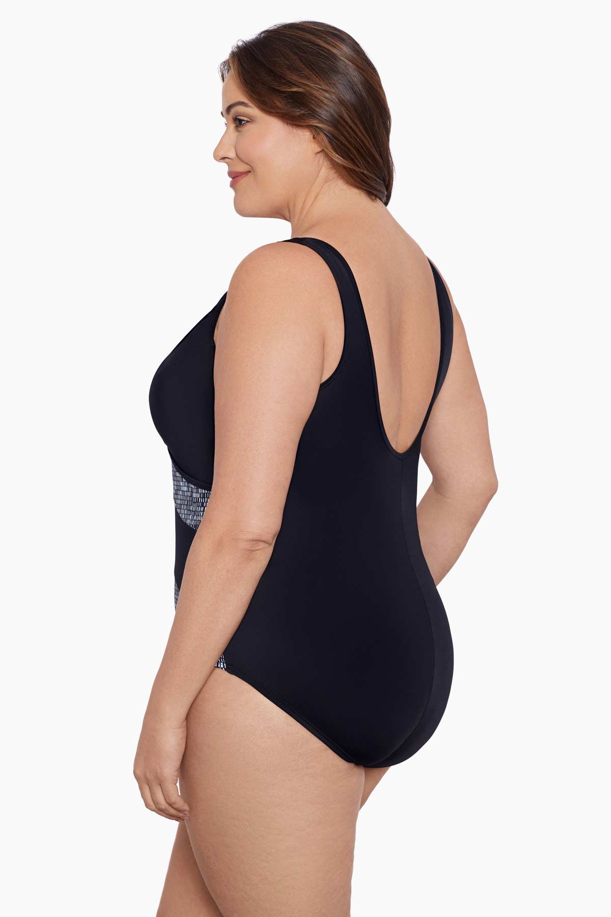 Woman turned left wearing a black and white black blocked one-piece swimsuit