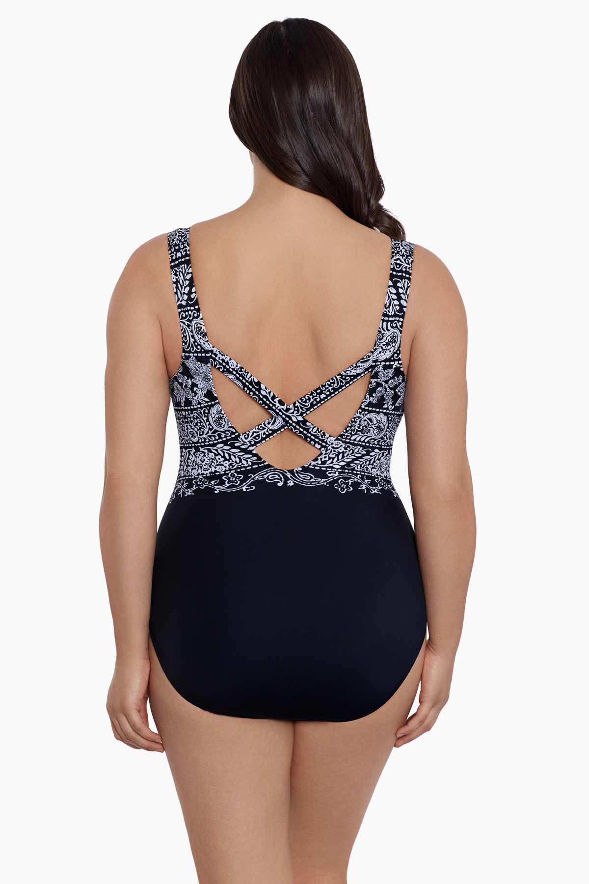Woman faced away wearing a black and white garland printed one-piece swimsuit
