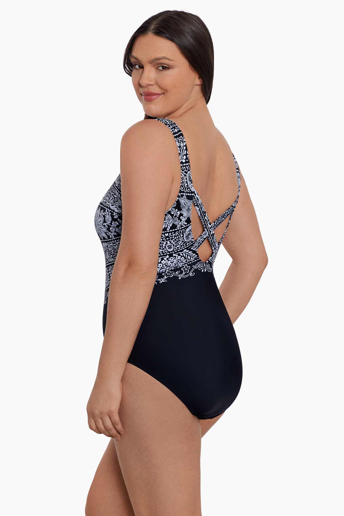 Woman turned left wearing a black and white garland printed one-piece swimsuit