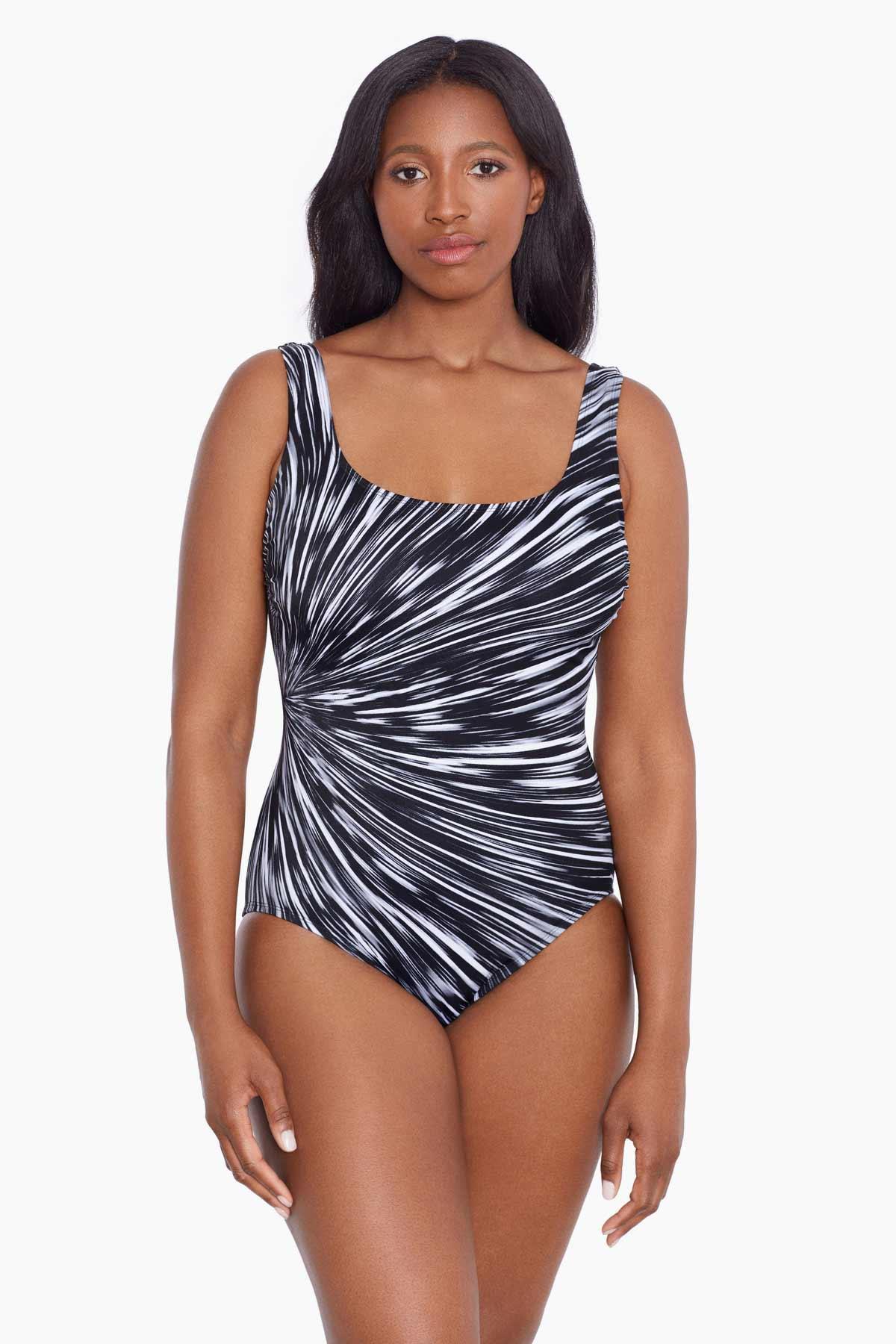Woman wearing a black and white radial printed one-piece swimsuit