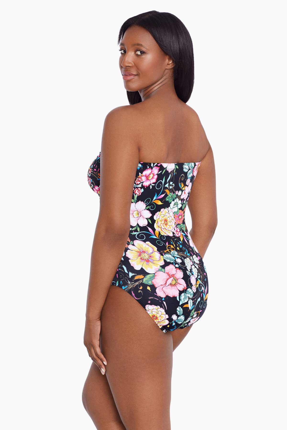 Woman turned left wearing a floral printed bandeau one-piece swimsuit