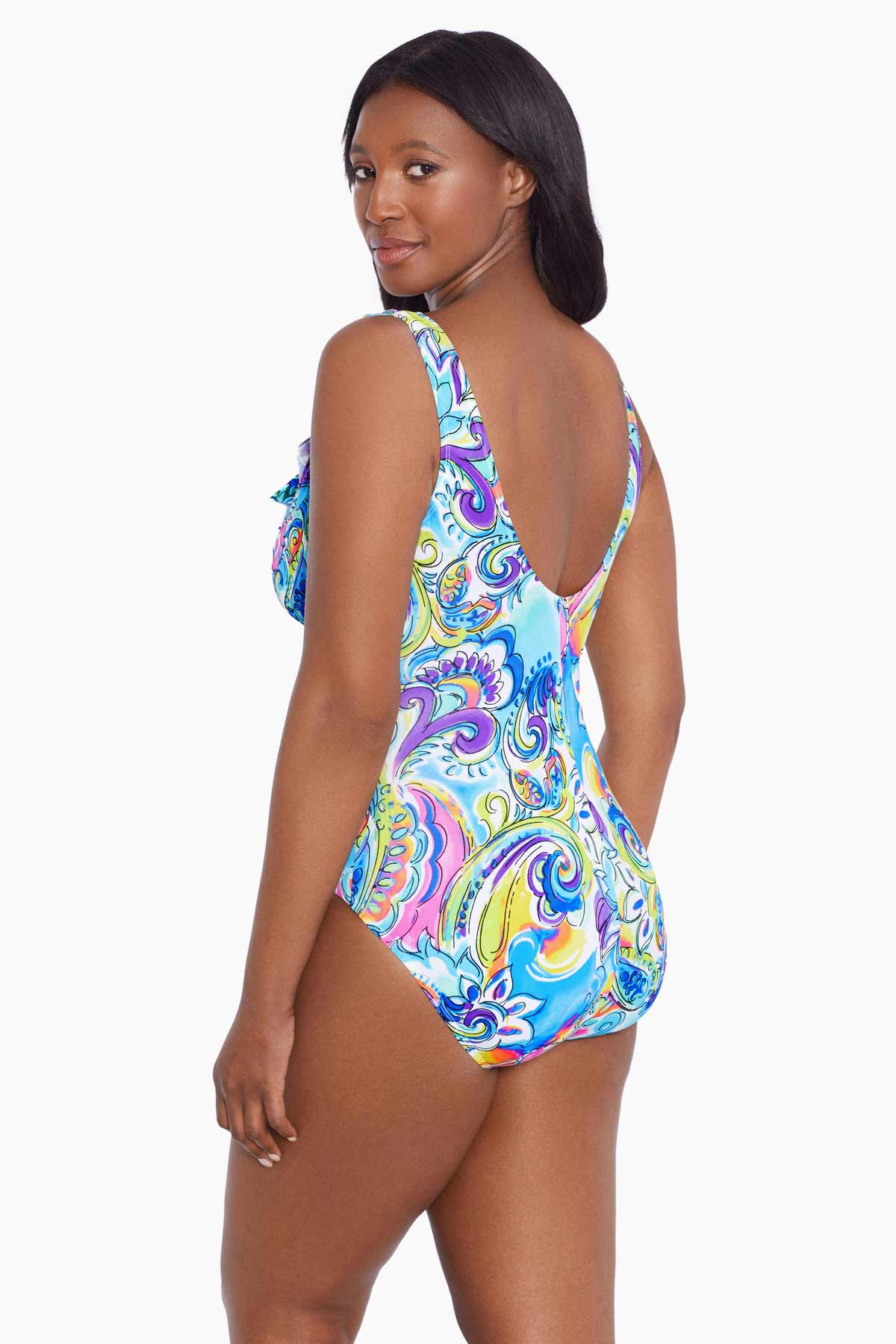 Woman faced left wearing a brightly colored paisley print one-piece swimsuit