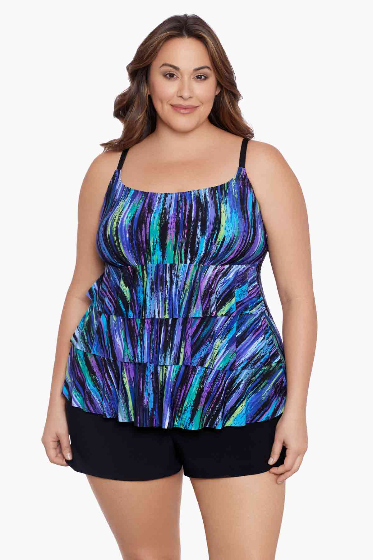Woman wearing a blue and green streak printed ruffle shortini swimsuit